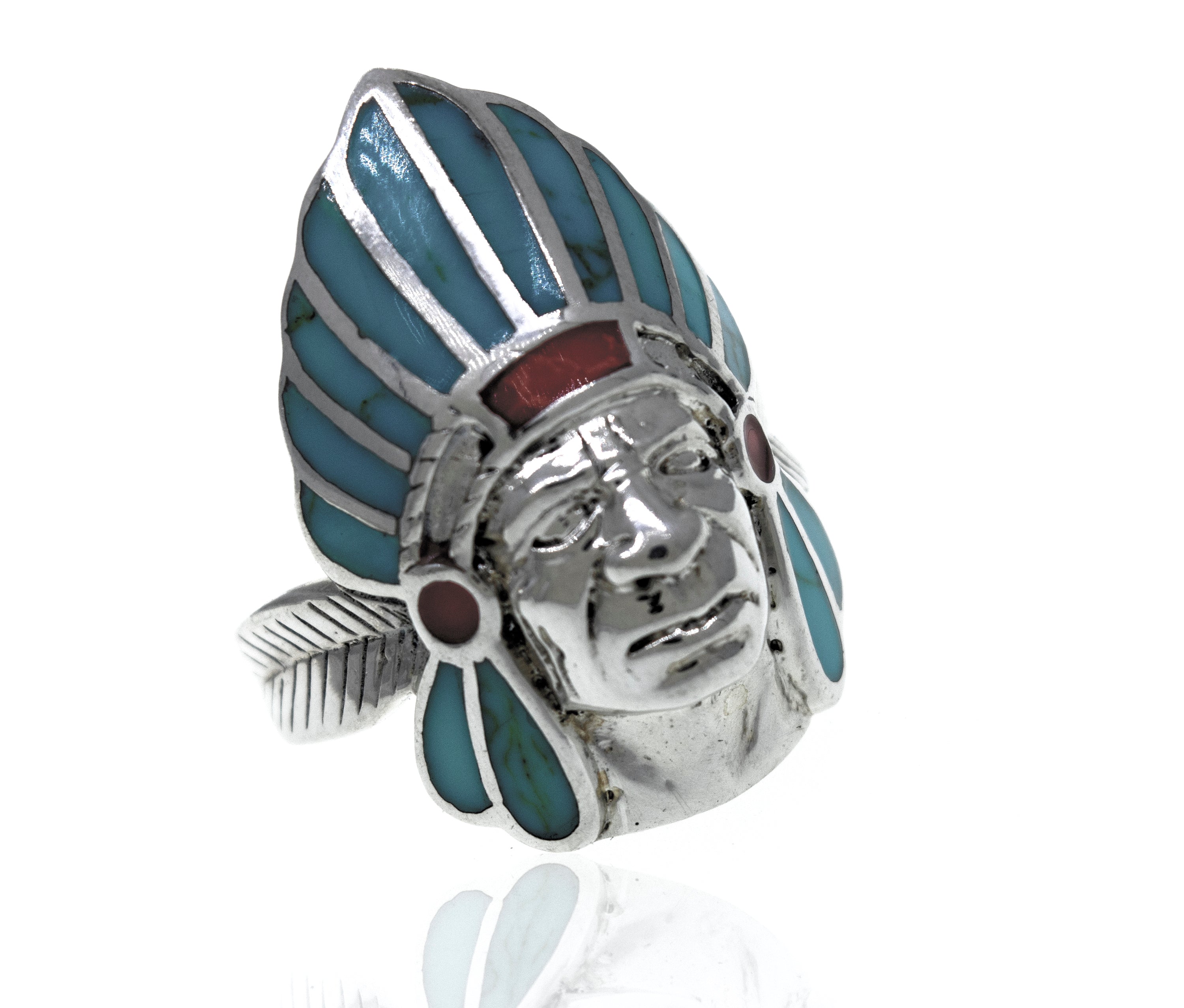 A sterling silver ring with a Turquoise And Coral Chief Head inlay.