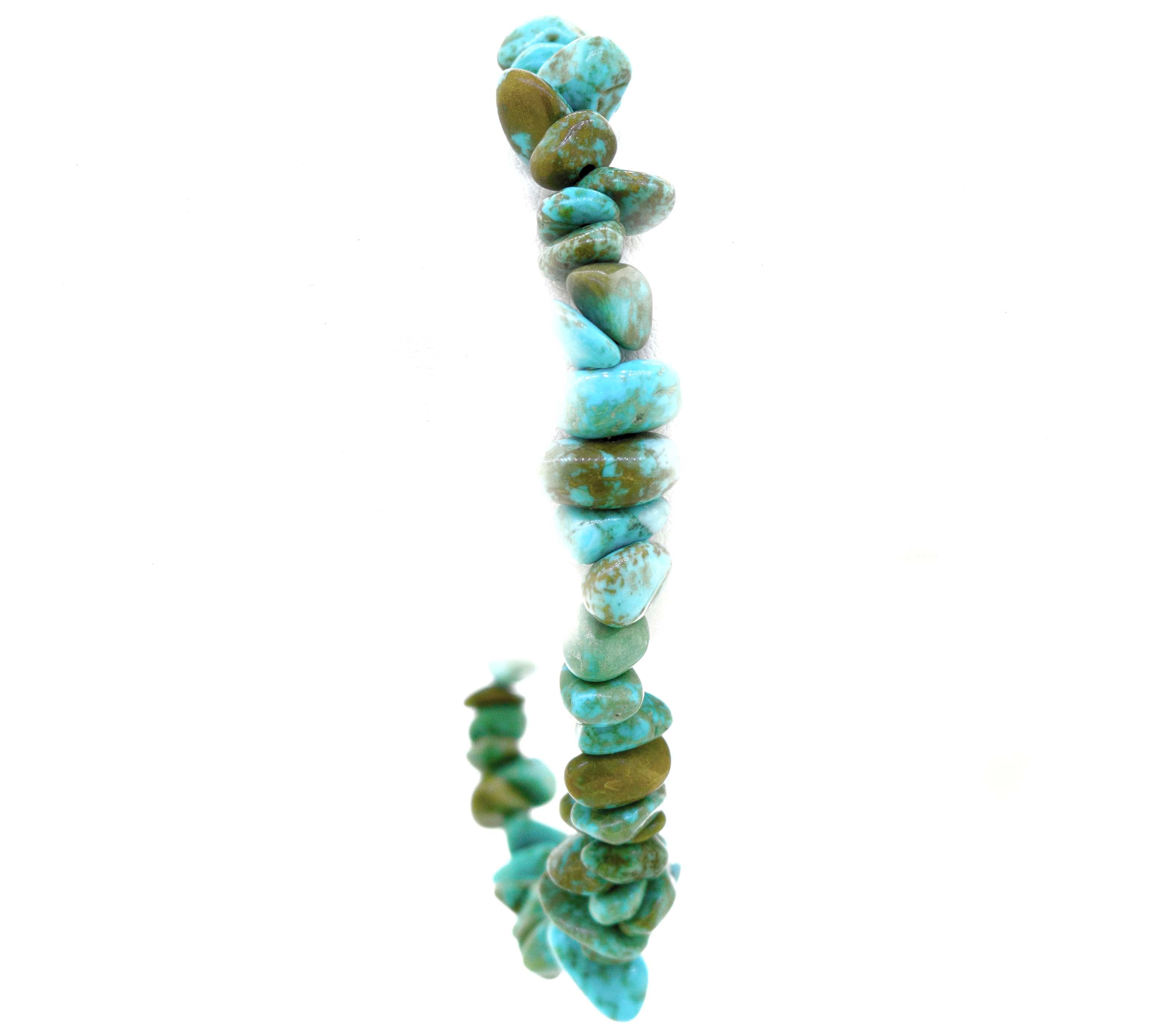 A string of irregularly shaped turquoise beads forming a Southwest Colorado Turquoise Chip Bracelet or Anklet against a white background, enhanced with .925 Sterling Silver accents for a touch of southwest charm.