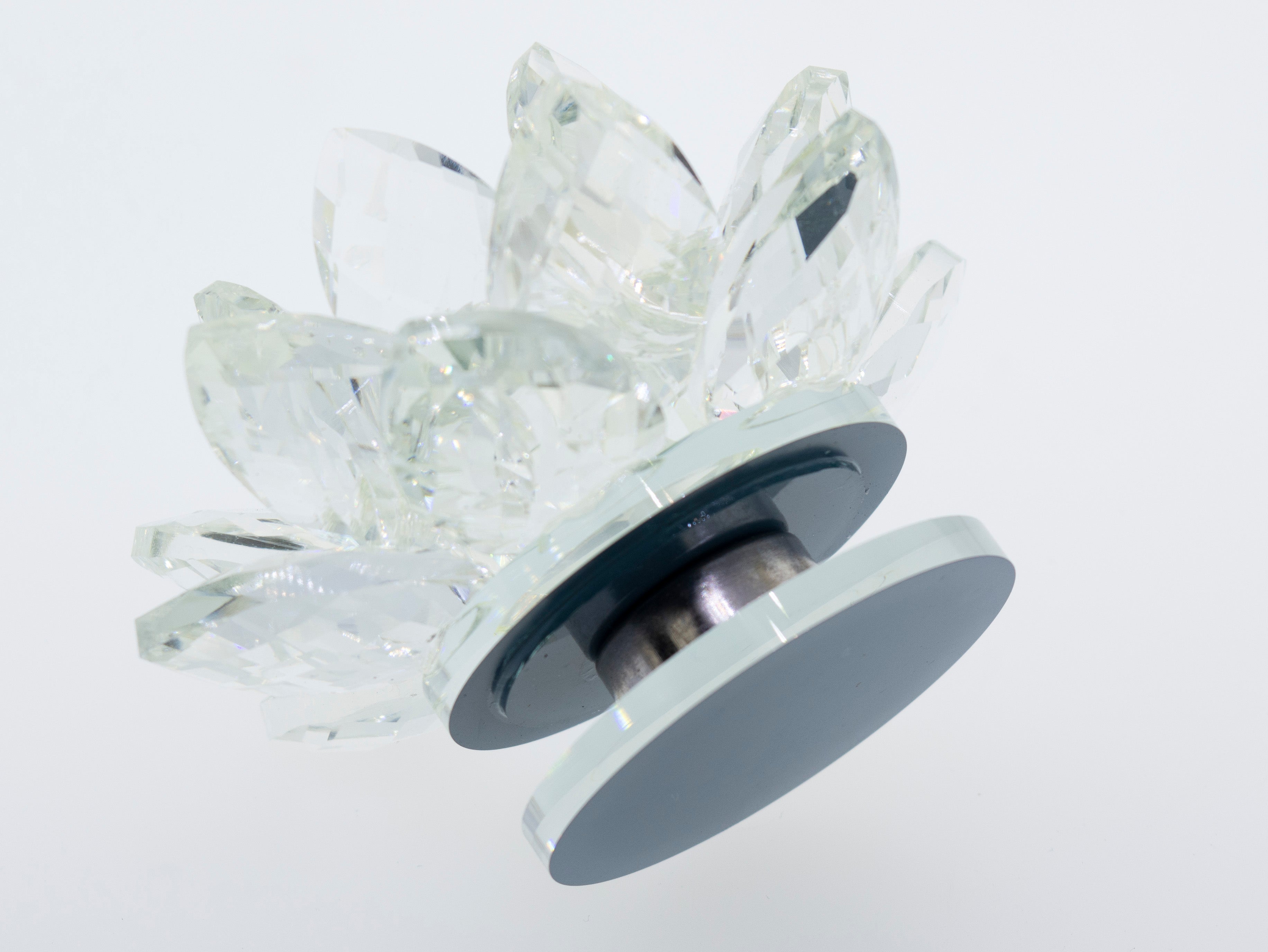 A statement Crystal Lotus Stand on a white surface with a black base, adding a unique touch to your decor.