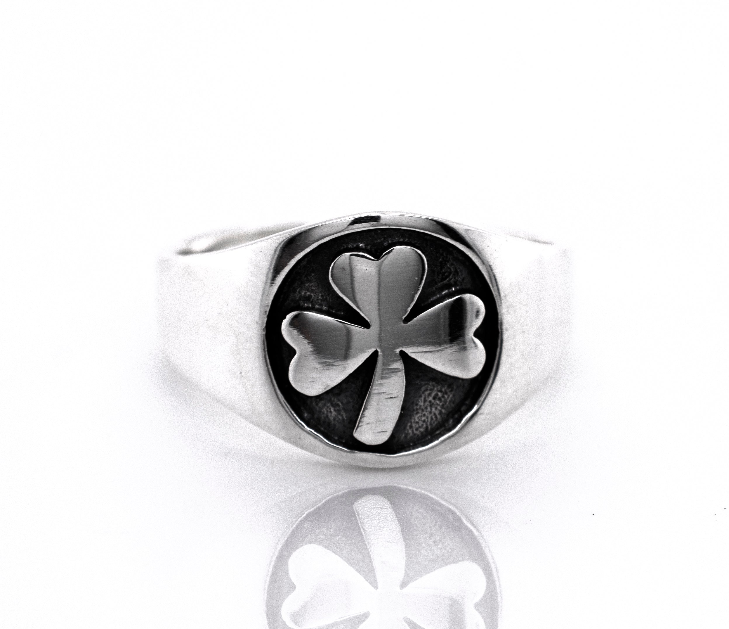An oxidized Super Silver Three Leaf Clover Band with a sterling silver band on a white background.
