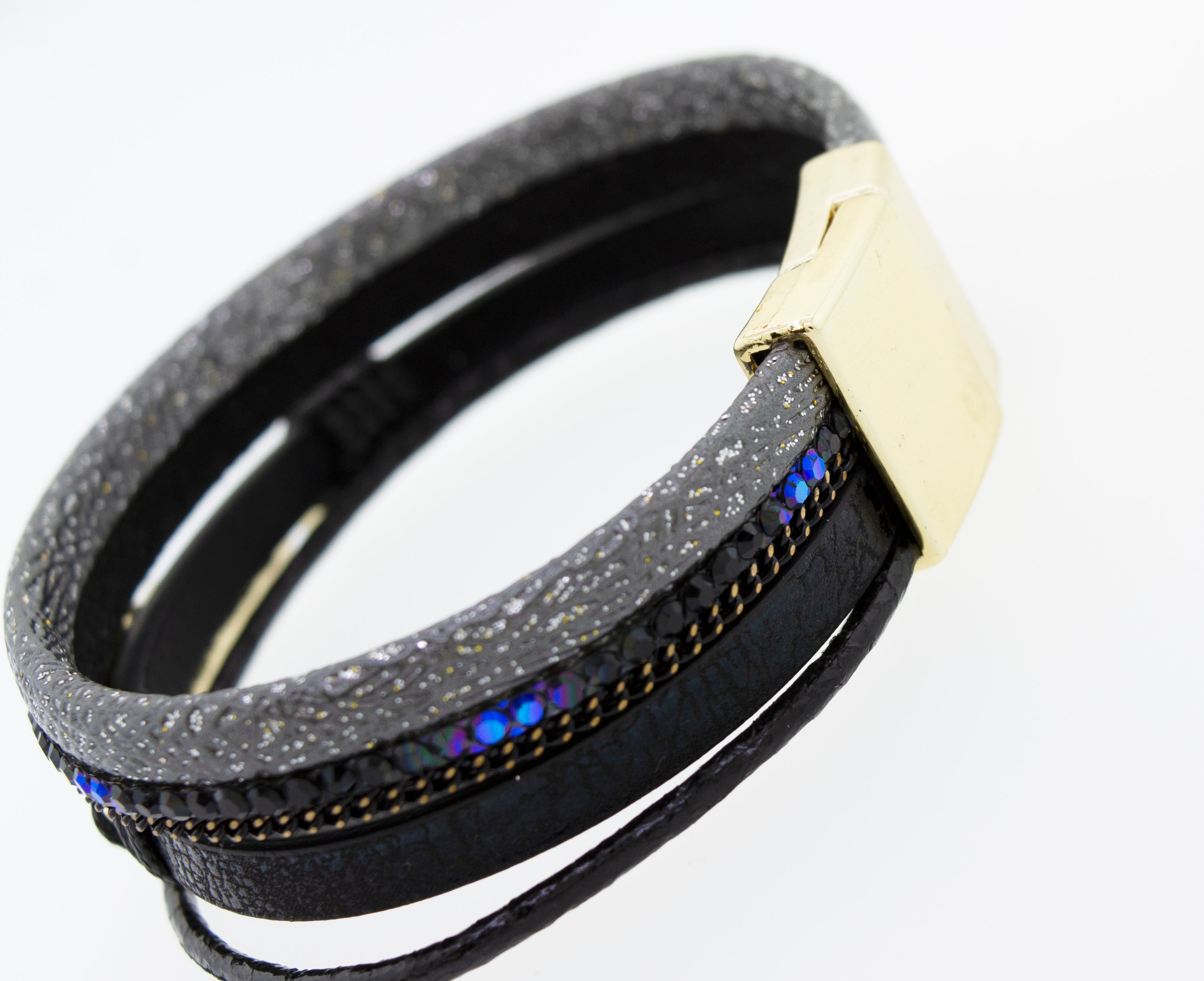 A Super Silver black magnet bracelet with a gold buckle.