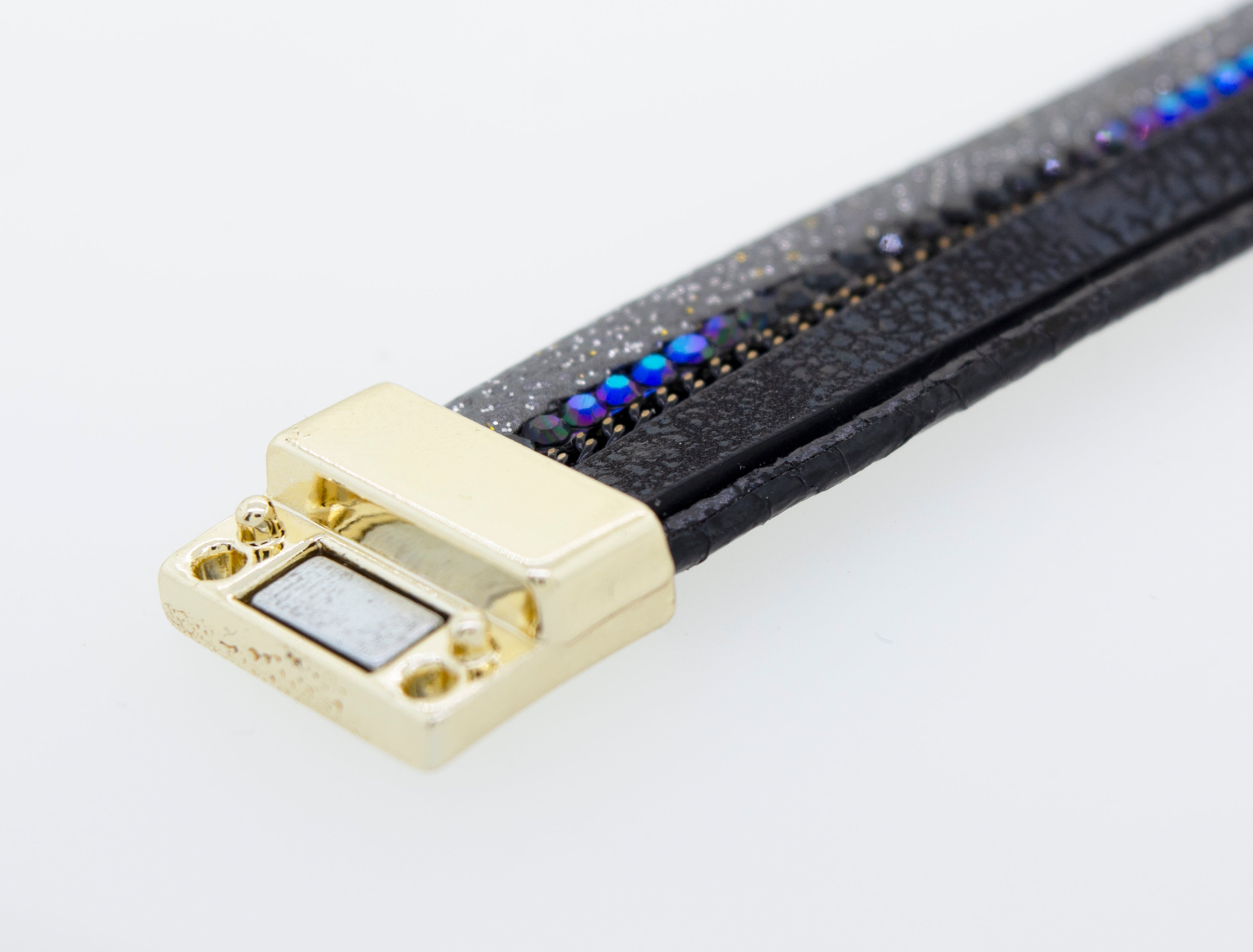 A Super Silver black faux leather bracelet adorned with blue and gold beads.