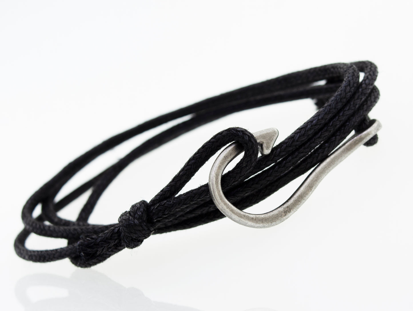 
                  
                    A Three Bracelet Set by Super Silver, consisting of a black chord bracelet with a hook and beads.
                  
                