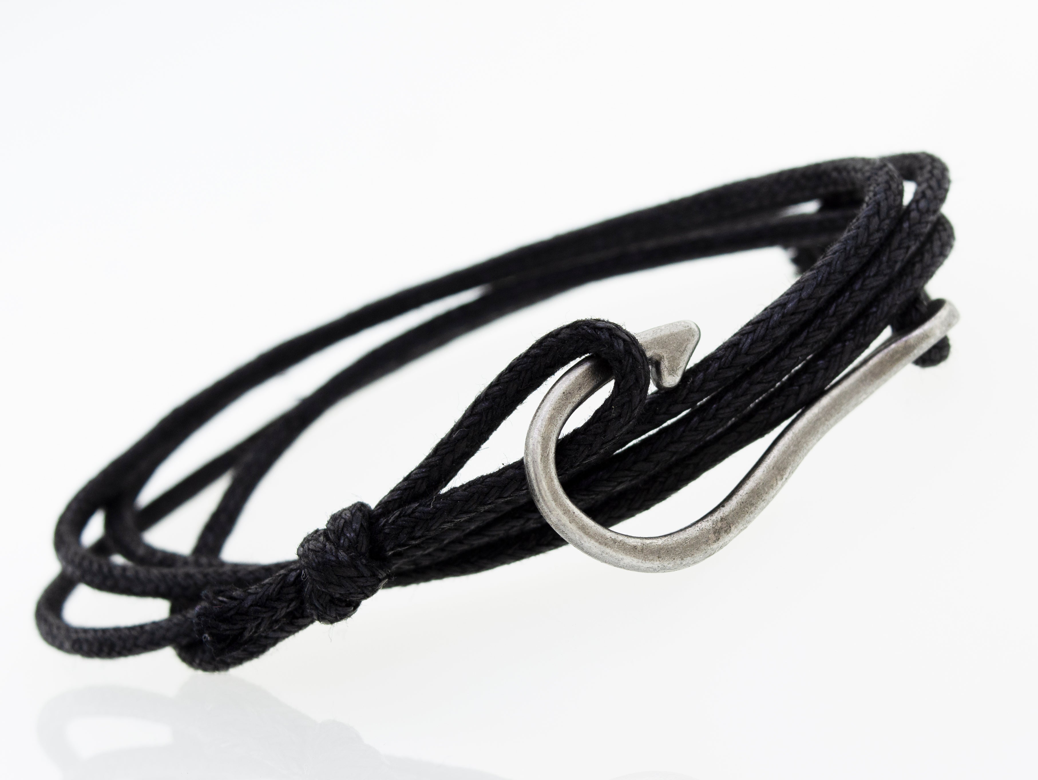 A Three Bracelet Set by Super Silver, consisting of a black chord bracelet with a hook and beads.