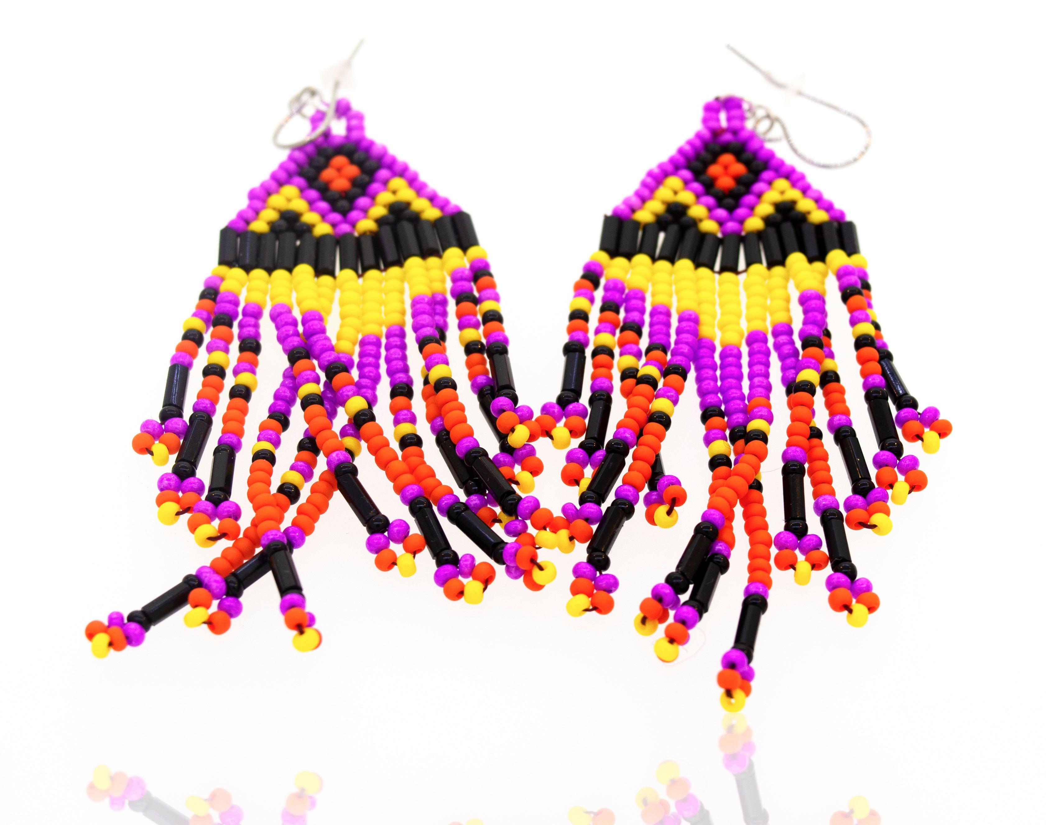 A pair of Super Silver southwest-inspired earrings with purple and yellow gemstone beads, displayed on a white surface.