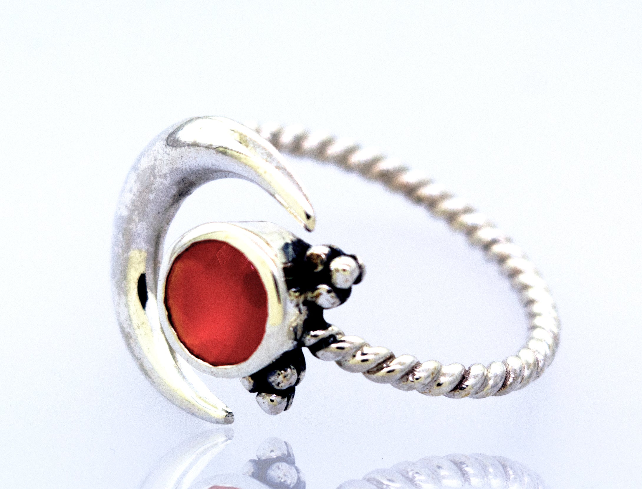 Online Only Exclusive Adjustable Carnelian Moon Ring with a twisted band, featuring a prominent carnelian crystal encased in a crescent moon setting, embellished with small diamonds.