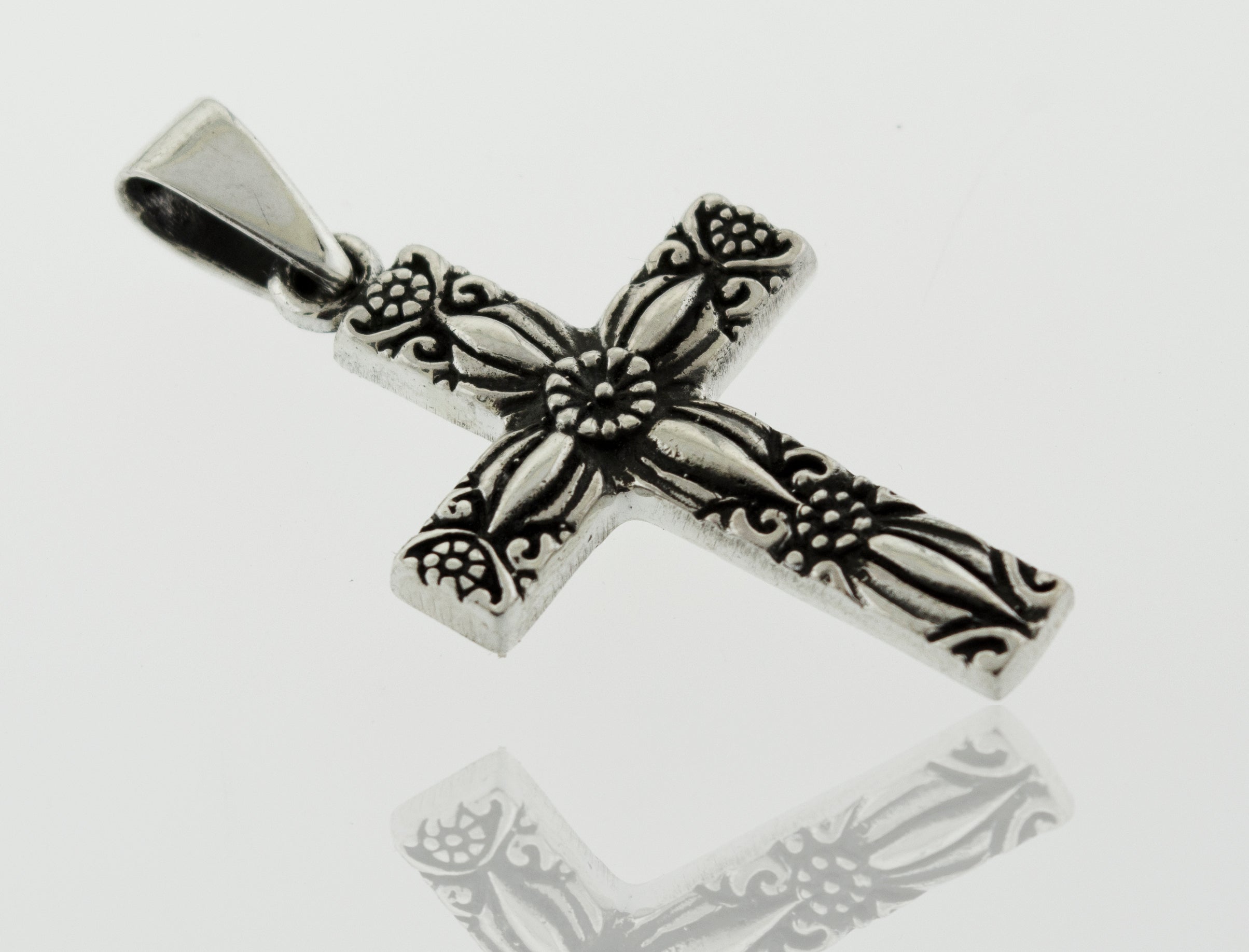 A Super Silver Cross Pendant With Flower Detail with an ornate design.