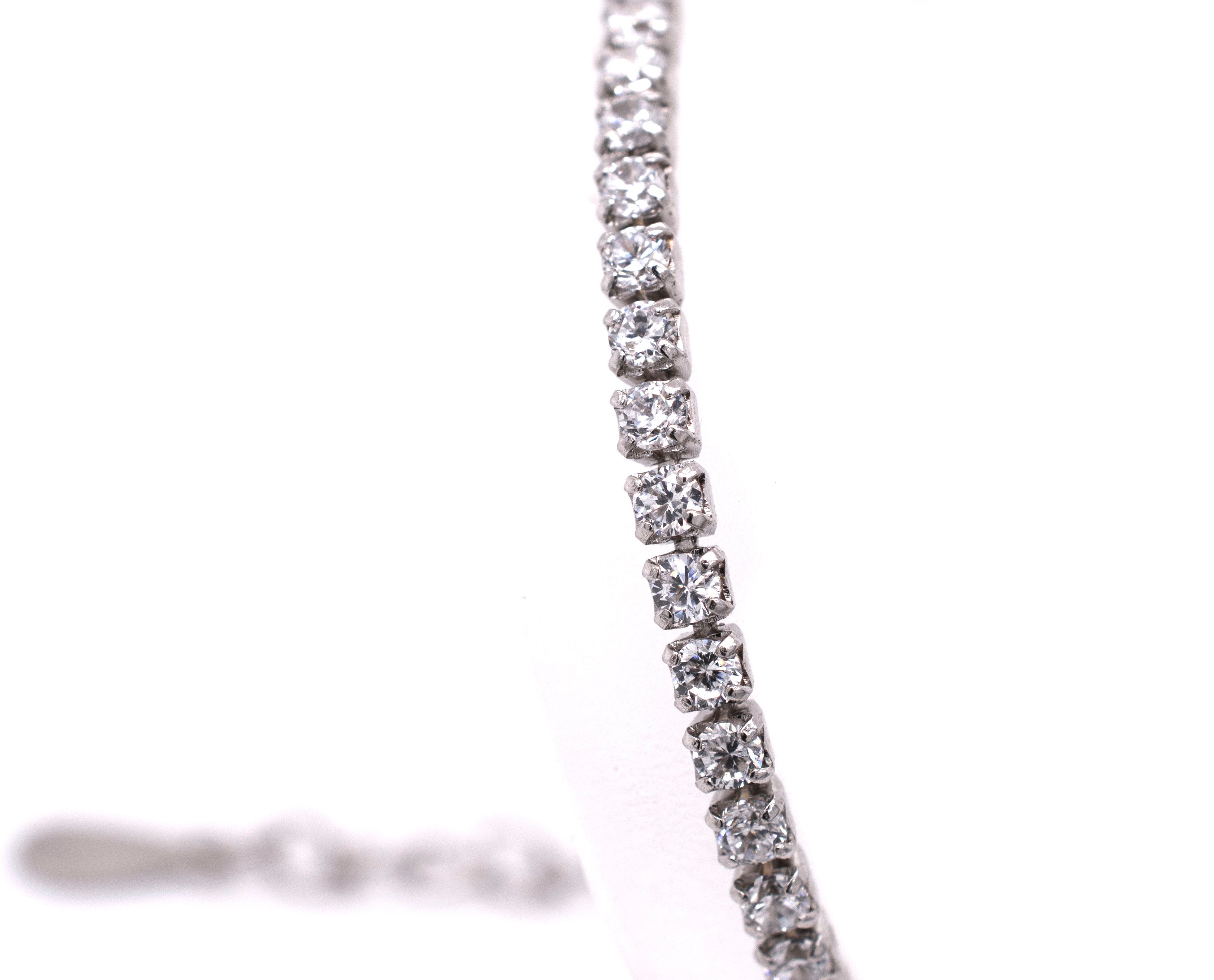 A sparkling Super Silver Square Cubic Zirconia tennis bracelet with diamonds.