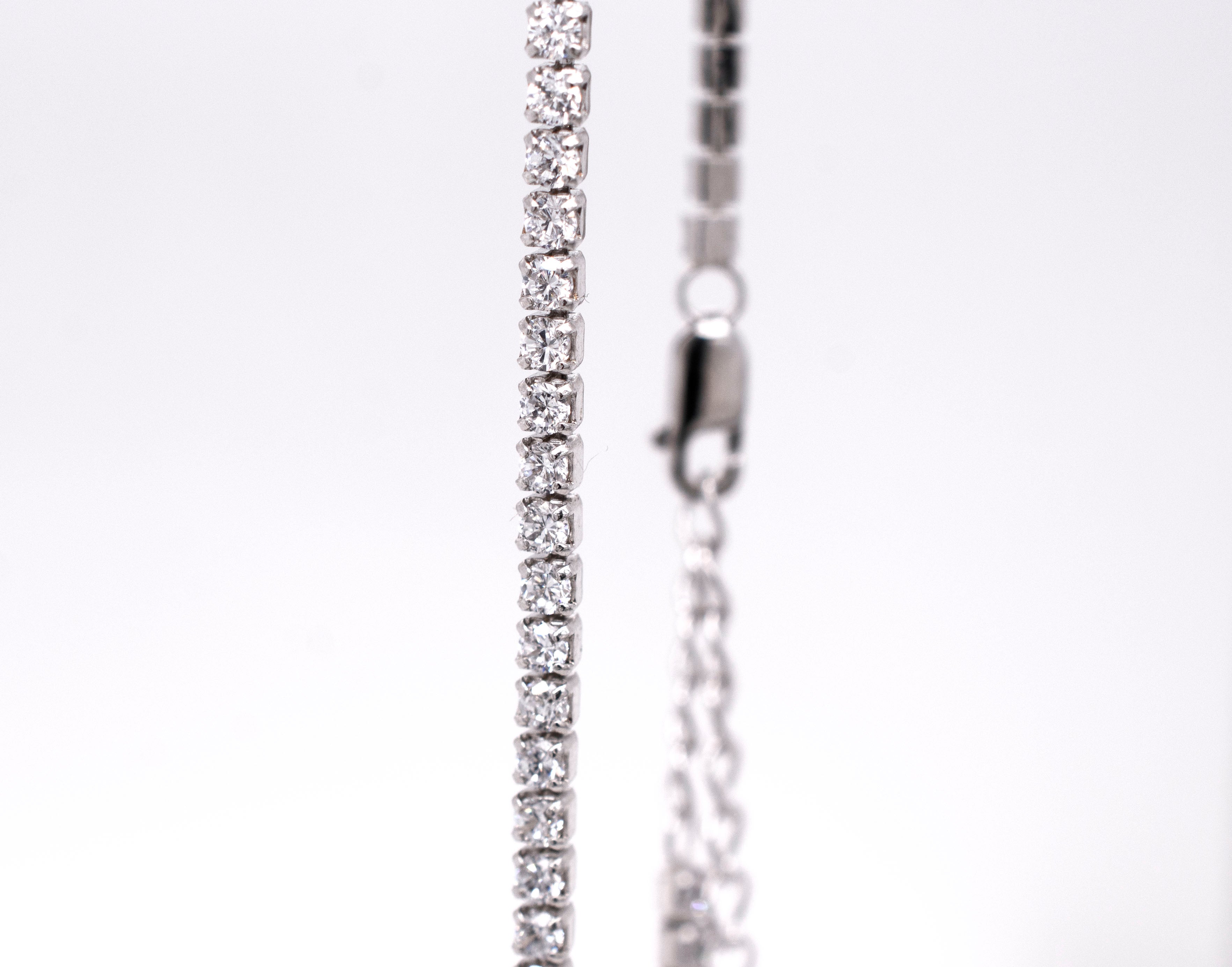 A sparkling elegance Super Silver white gold necklace with diamonds on it.