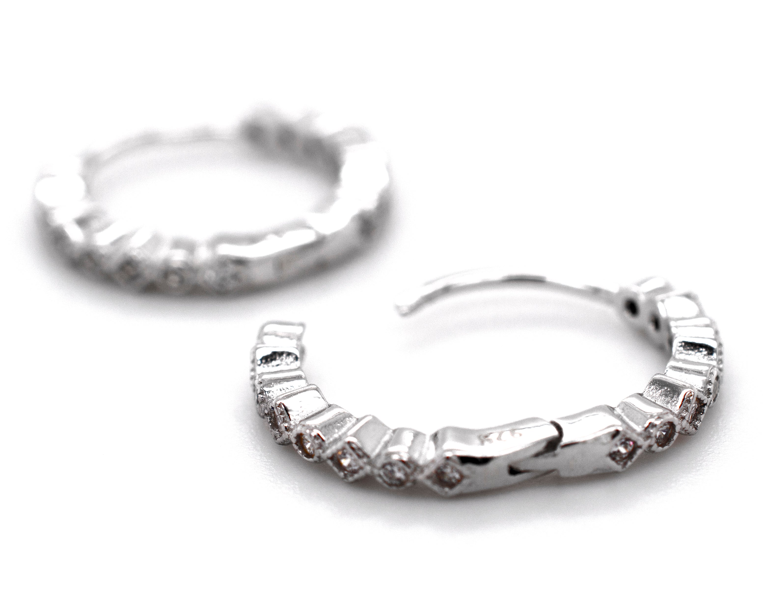 A pair of Fashionable Geometric CZ Hoops by Super Silver with diamonds.