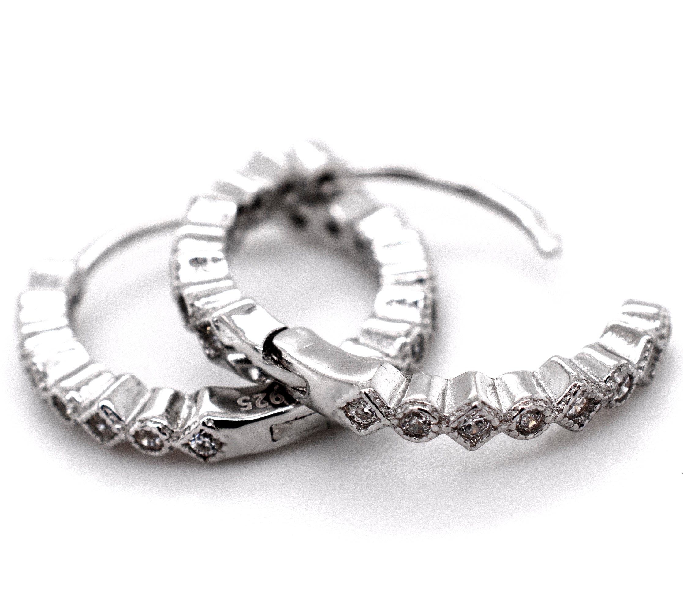 A pair of Fashionable Geometric CZ Hoops by Super Silver with a minimalist design.