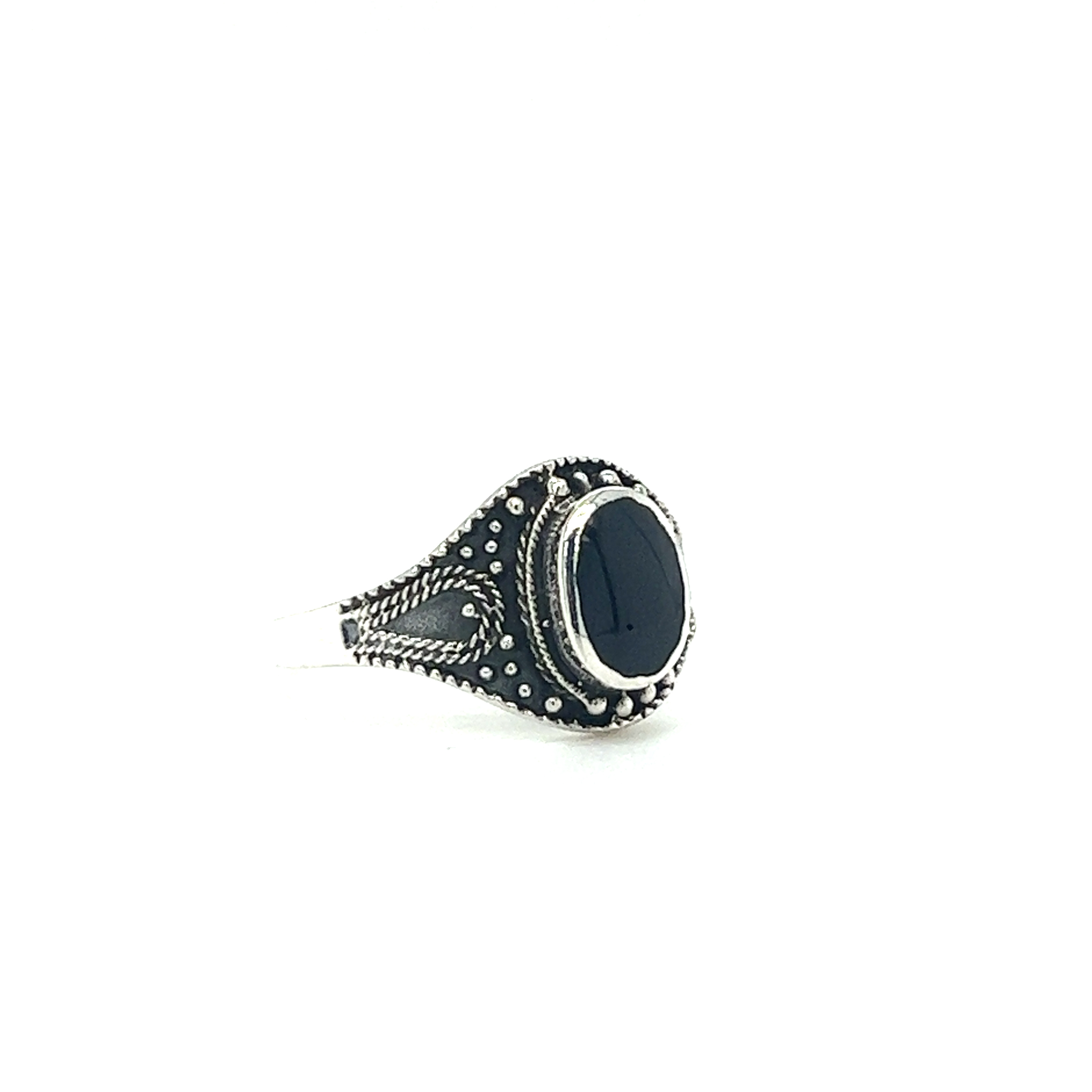 A Vintage Style Oval Shield Ring with Inlaid Stones silver ring with a black onyx stone.