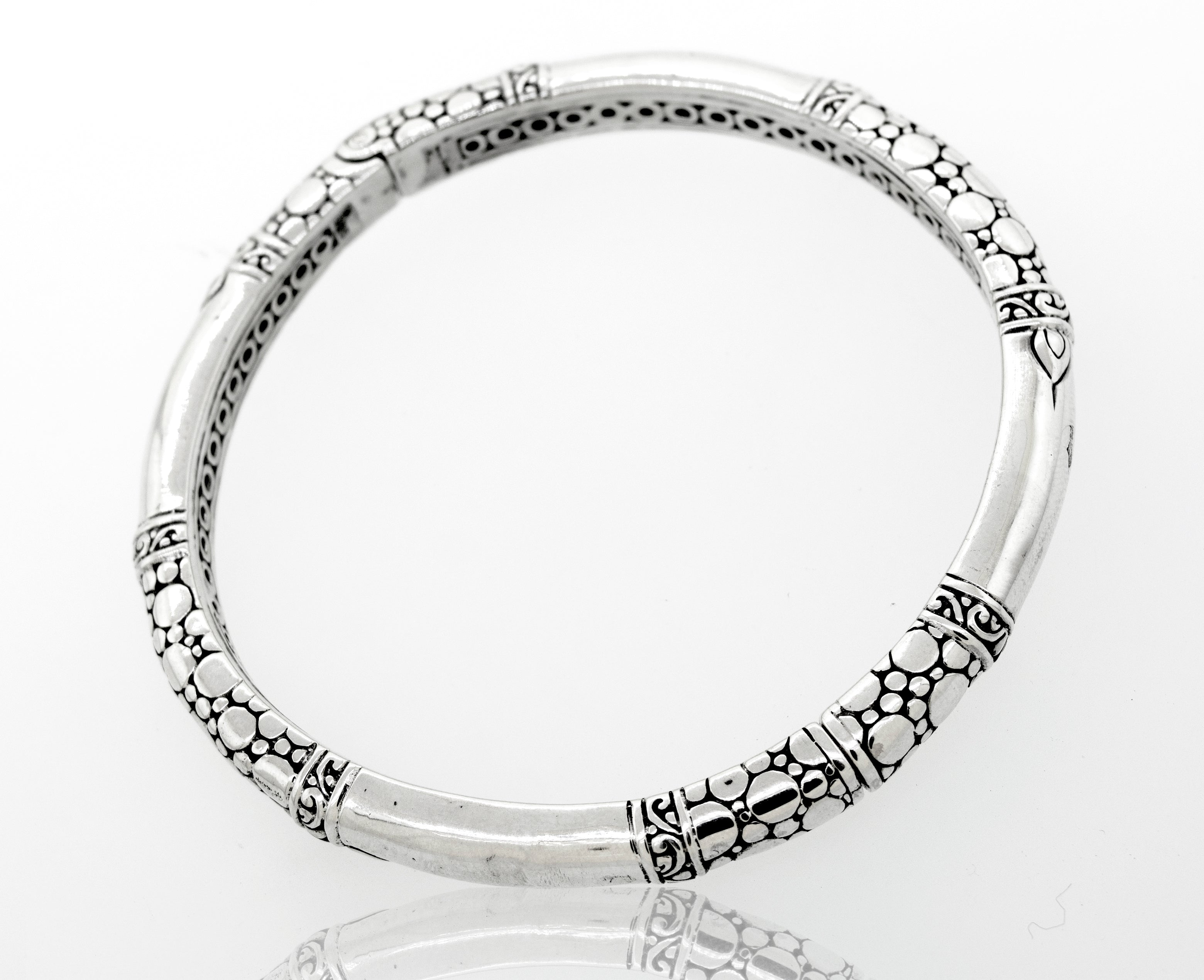 A Super Silver sterling silver handmade designer bangle with an intricate bubble design and latch mechanism.
