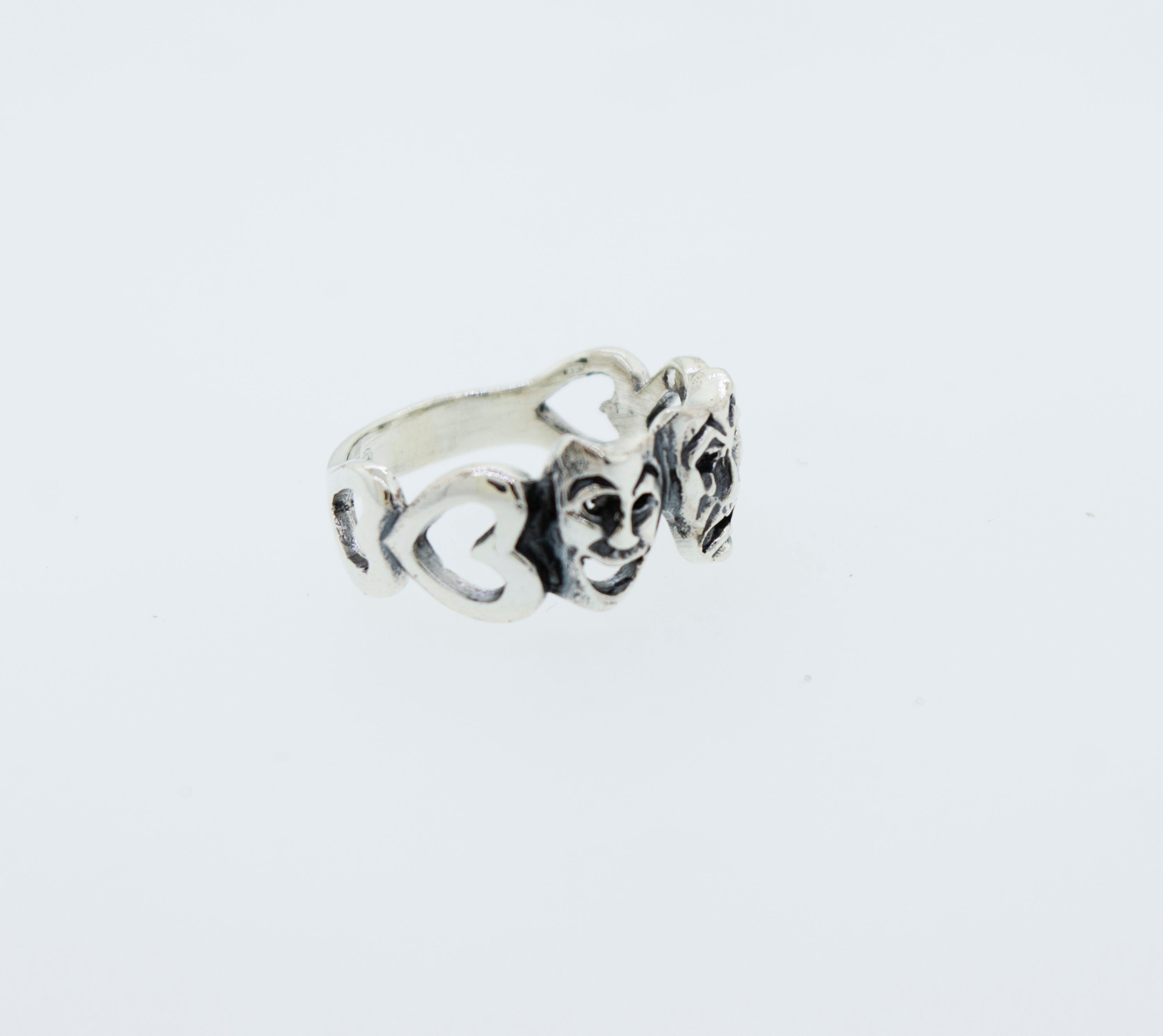A Super Silver Comedy and Tragedy ring in .925 silver with three faces on it.