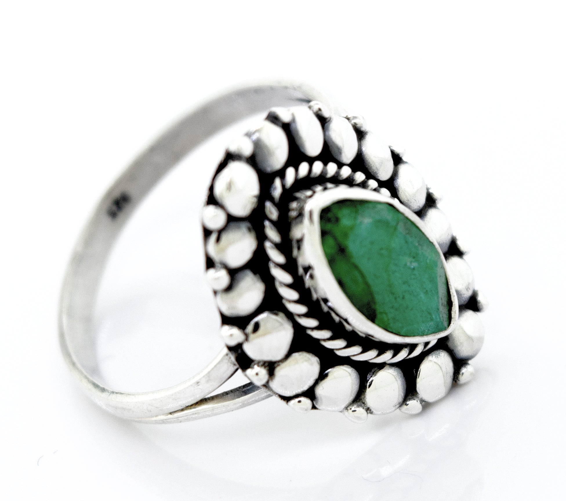 A Super Silver Marquise Shaped Vibrant Emerald Ring with a beaded design.