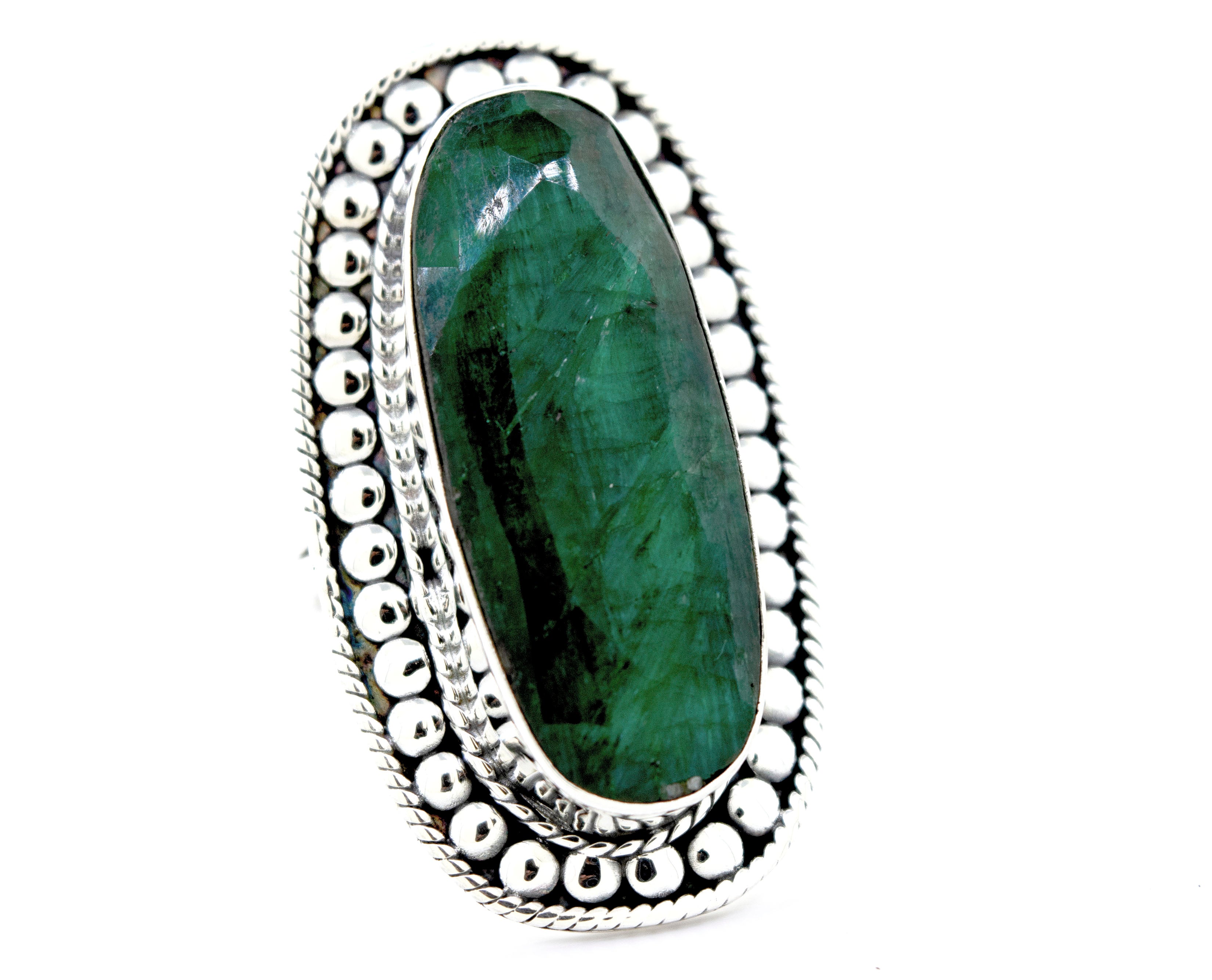A Super Silver Elegant Raw Emerald Ring with an oval emerald stone.