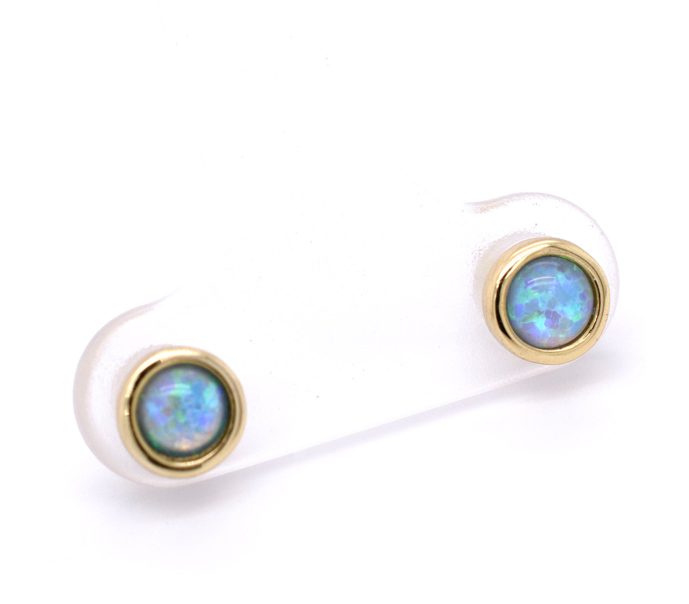 A pair of Super Silver Radiant Australian Opal Studs in brilliant blue on a white background.