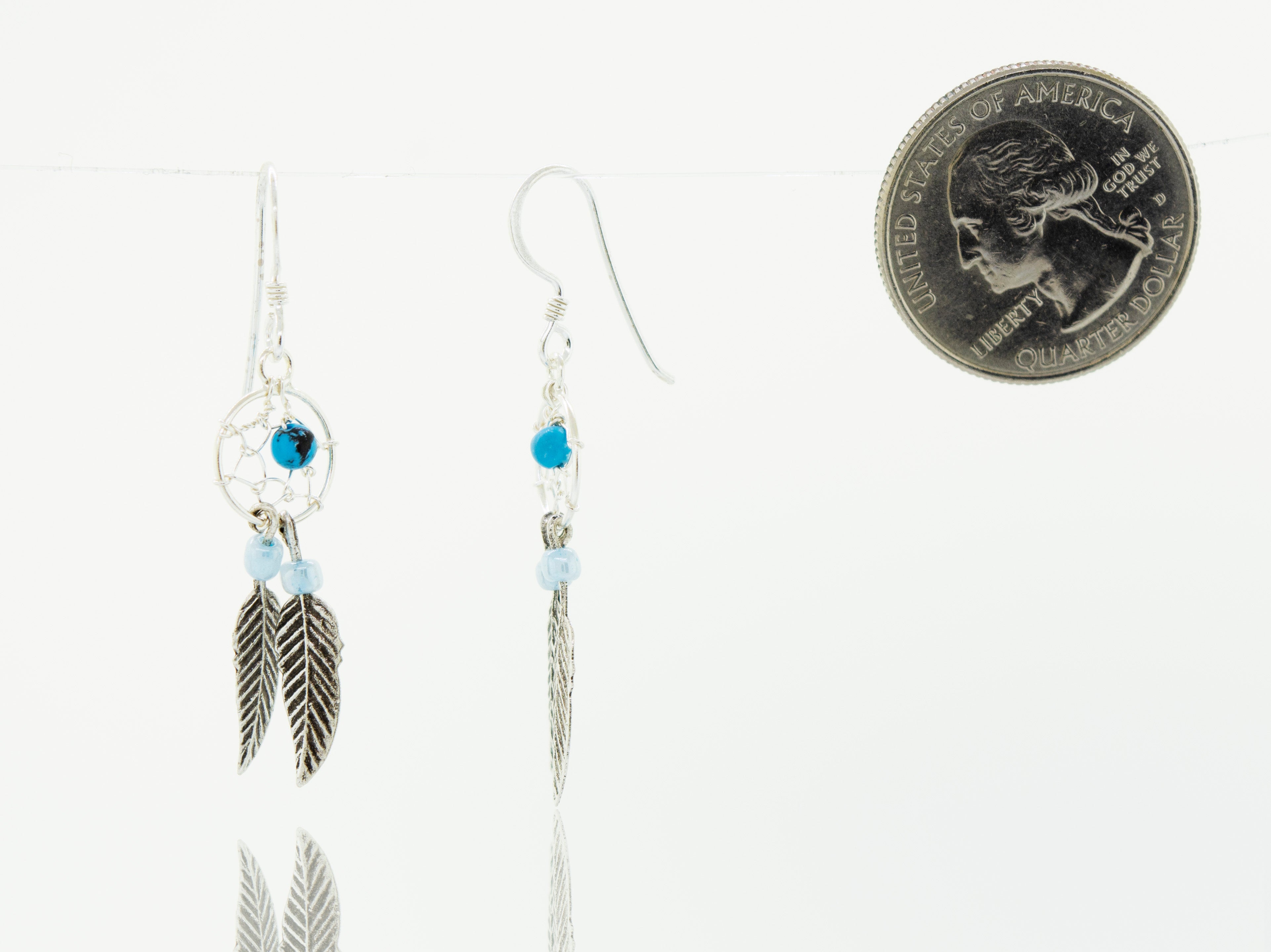 Super Silver's Turquoise Dreamcatcher Earrings with Feathers and a coin.