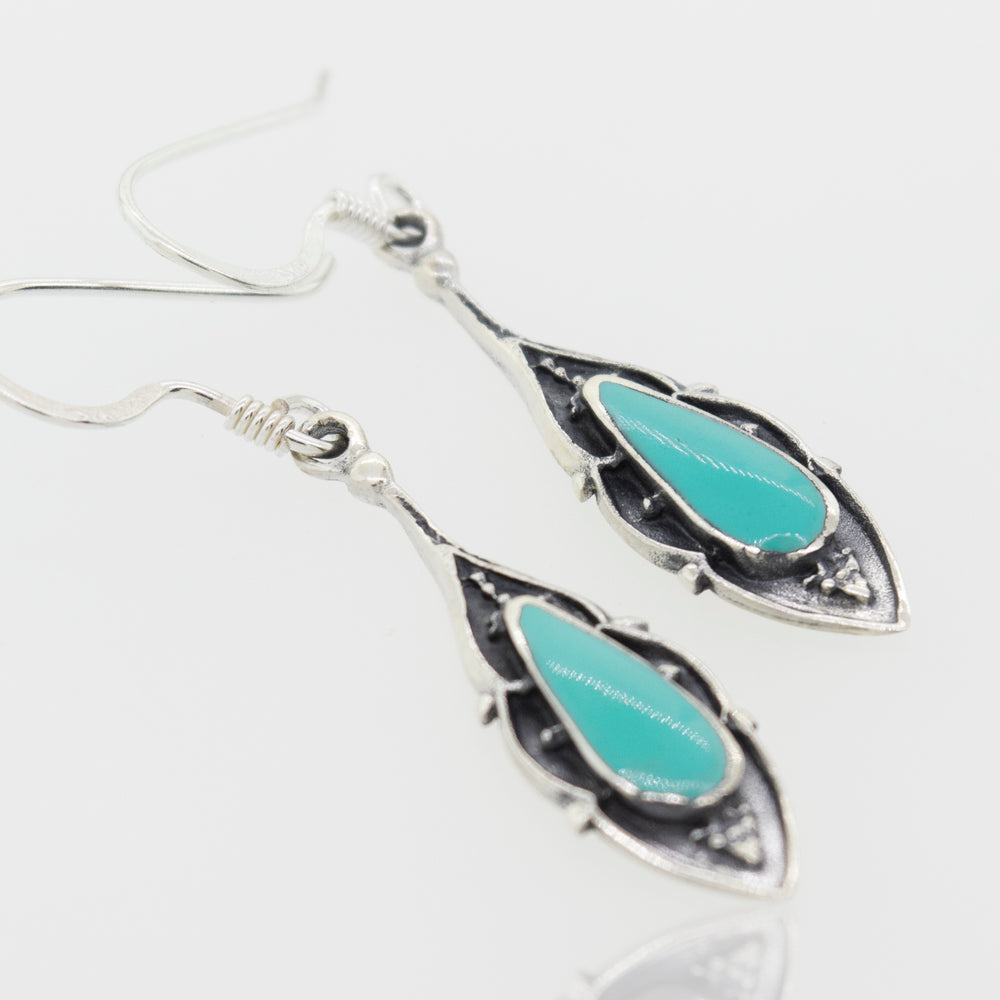 A pair of Super Silver Bali Inspired Turquoise Teardrop Earrings with green turquoise stones.