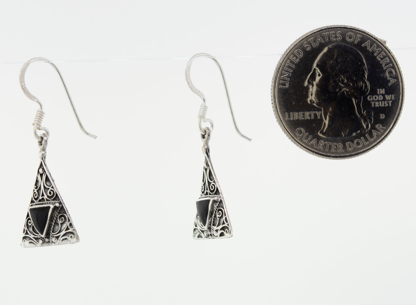A Super Silver freestyle pair of Freestyle Design Triangle Shape Onyx Earrings accented with a silver penny in front.