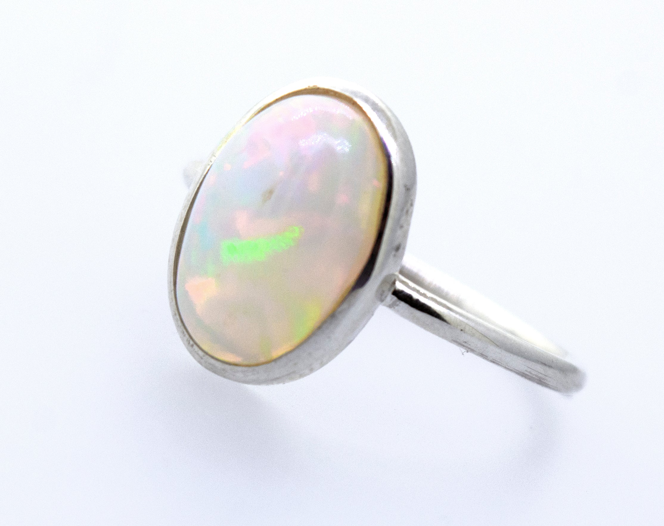 An Ethiopian Opal Ring with Oval Stone on a white surface.