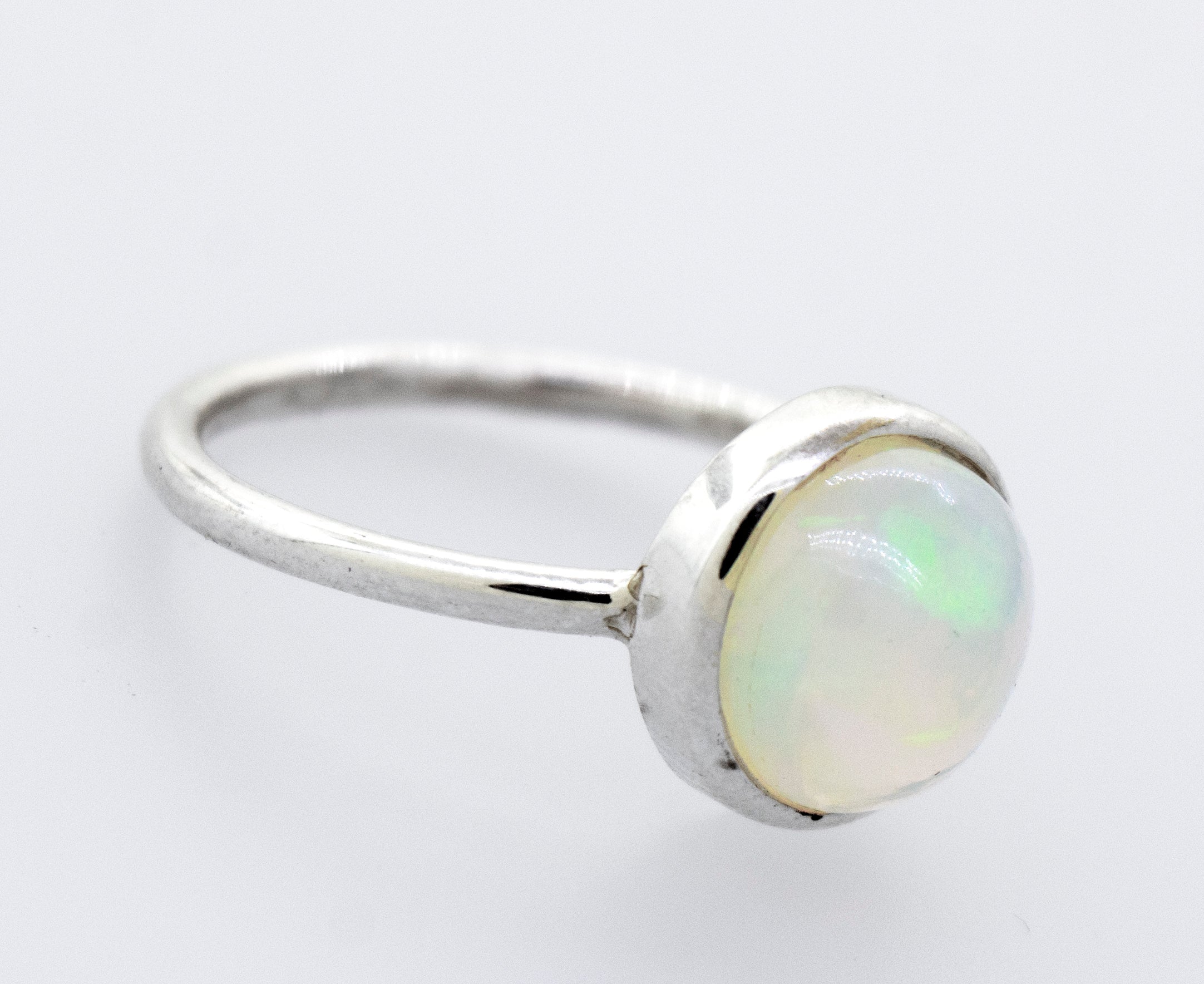 A stunning Round Ethiopian Opal Ring on a white surface.