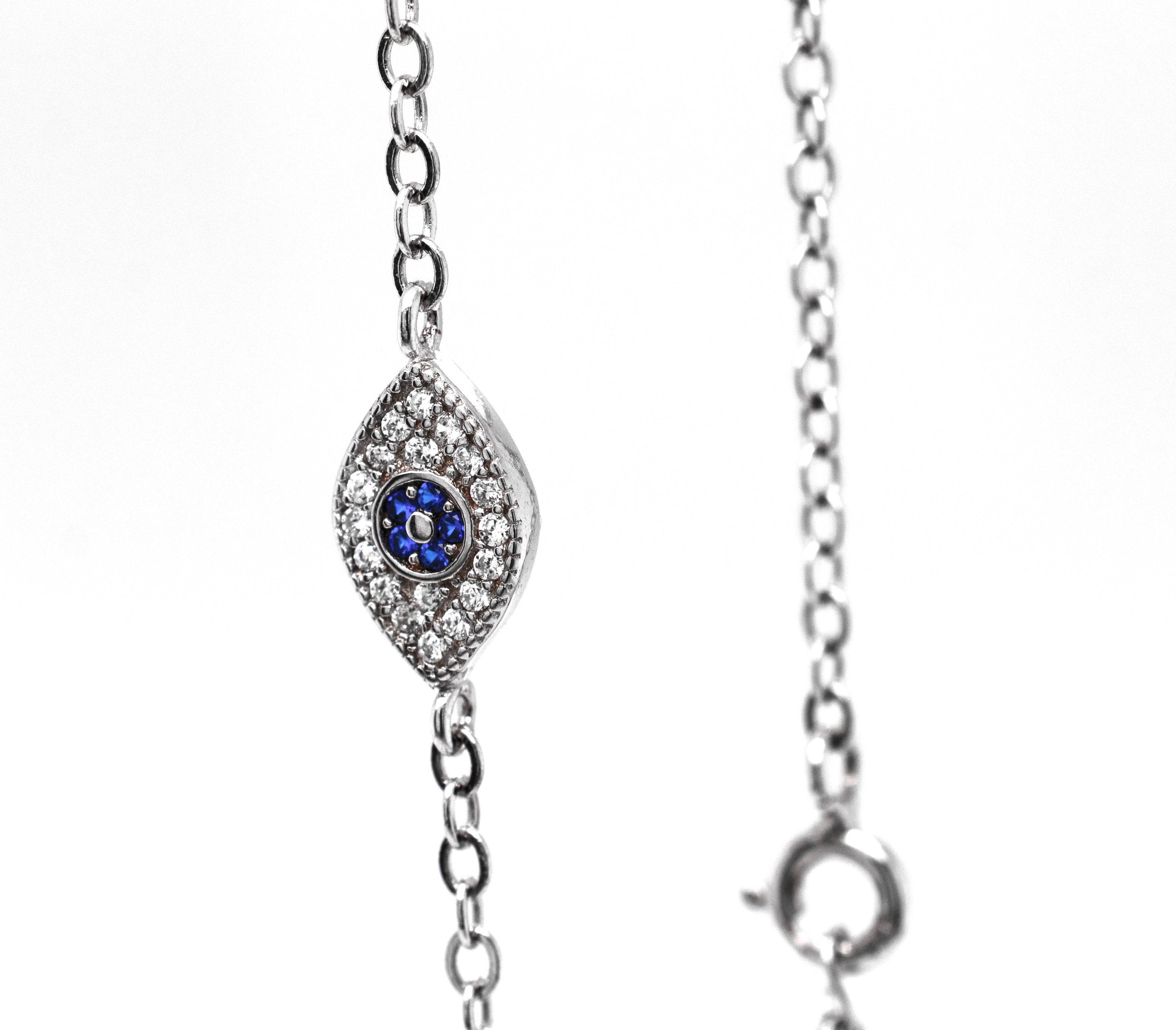A stunning Classic Blue Pave Cubic Zirconia Evil Eye Bracelet adorned with exquisite diamonds and sapphires from Super Silver.