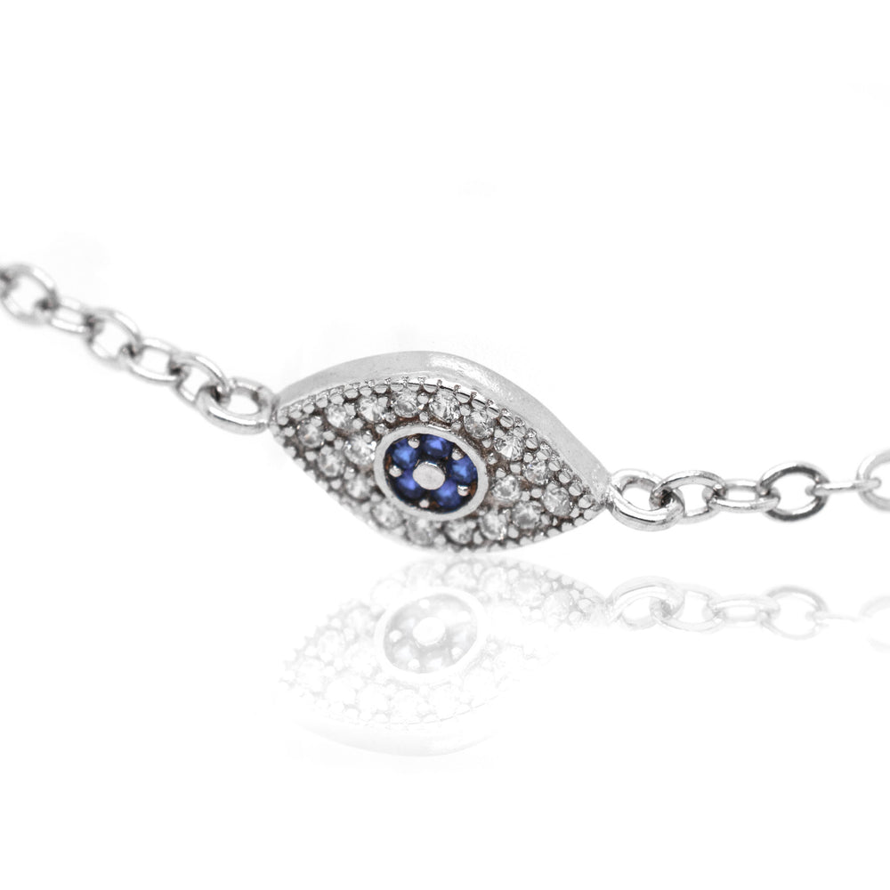 A stunning Classic Blue Pave Cubic Zirconia Evil Eye Bracelet adorned with blue sapphires and diamonds, crafted in sterling silver by Super Silver for an exquisite touch of elegance.