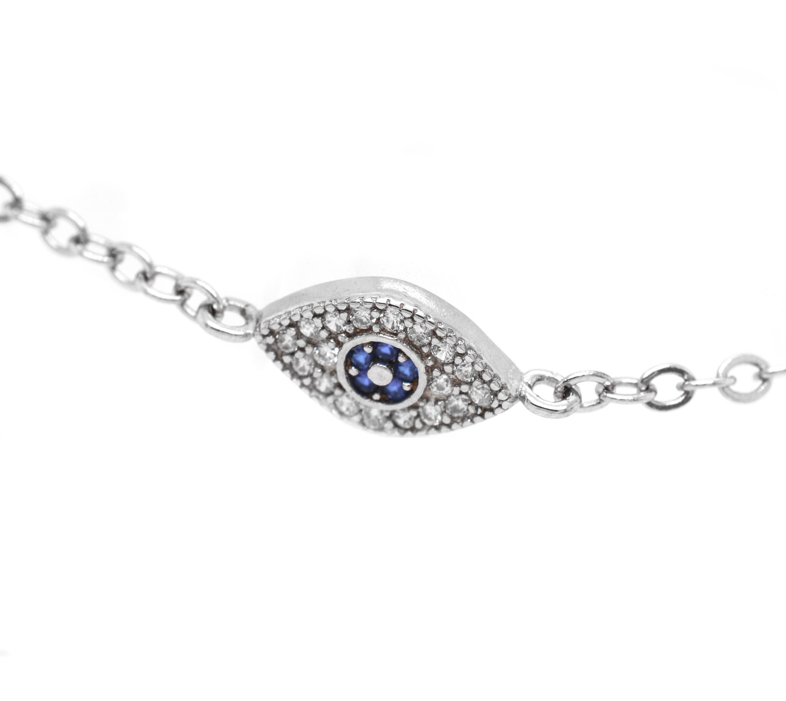 A stunning Classic Blue Pave Cubic Zirconia Evil Eye Bracelet adorned with blue sapphires and diamonds, crafted in sterling silver by Super Silver for an exquisite touch of elegance.