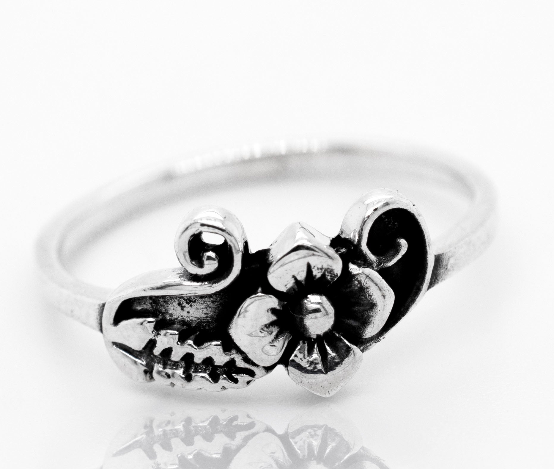 A boho-inspired Flower With Leaf And Swirl Design Ring, reminiscent of the vibrant Santa Cruz style.