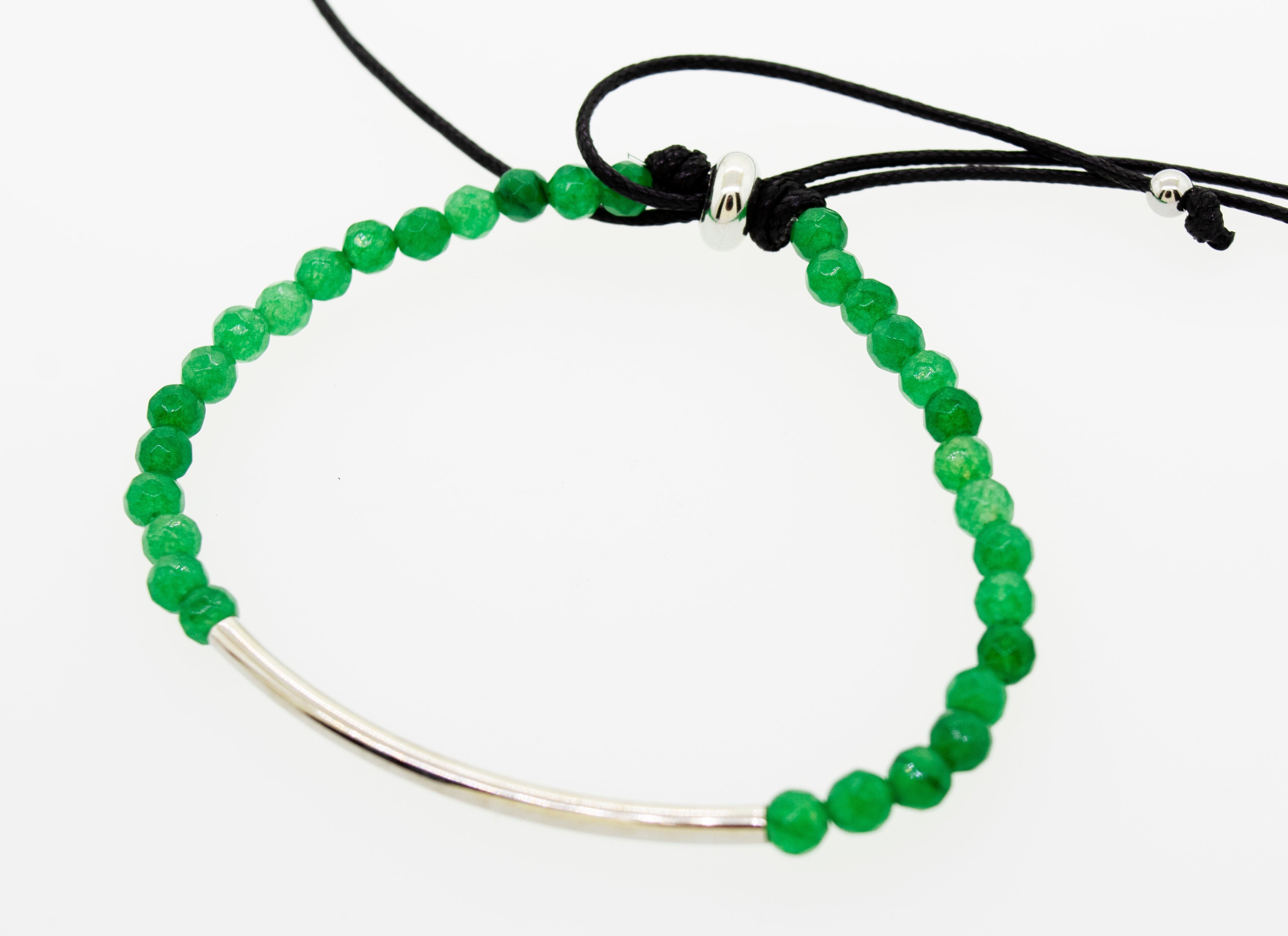 A Super Silver Adjustable Gemstone Bead Bracelet with a green beaded band and a sleek silver bar.