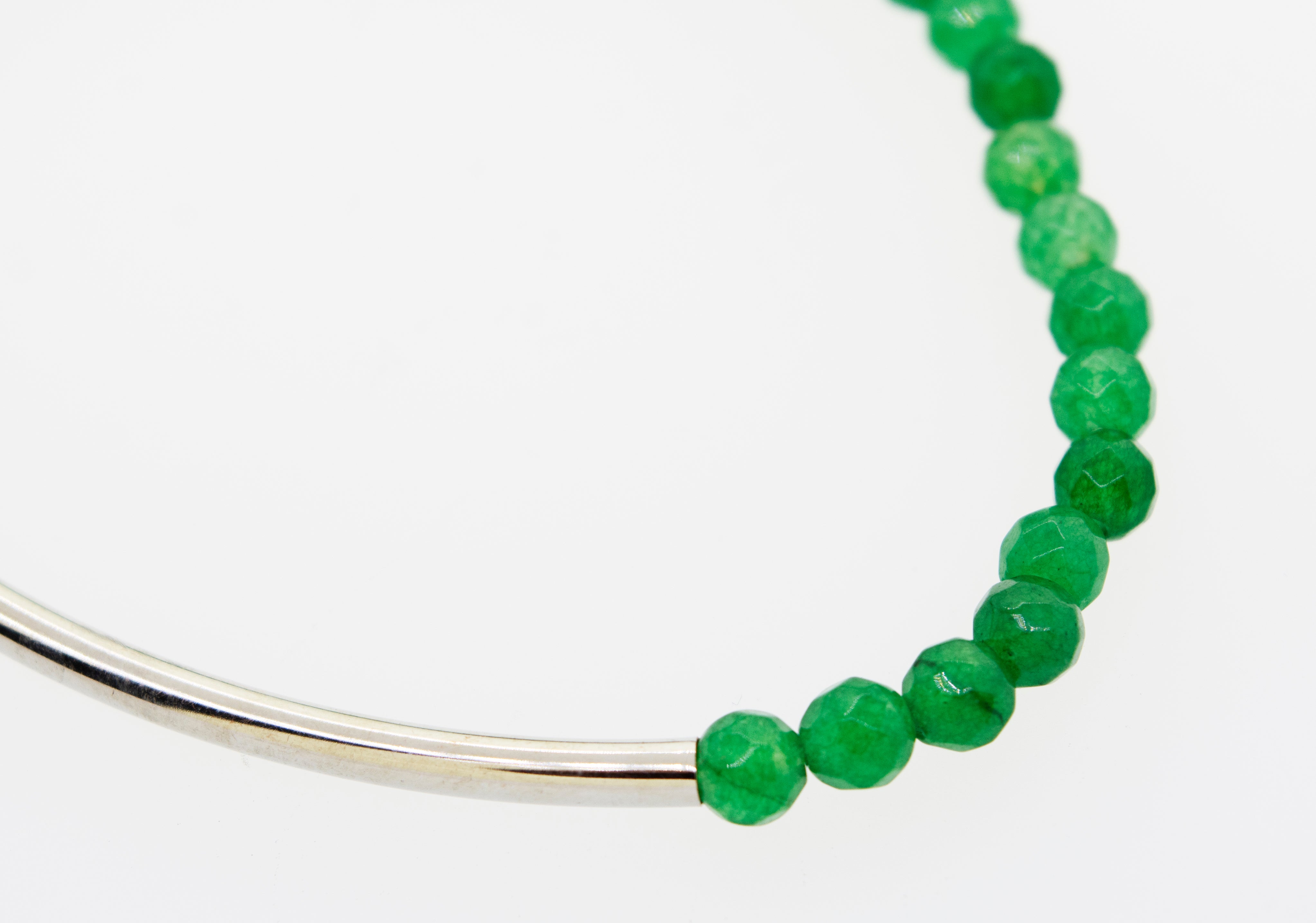 A Super Silver Adjustable Gemstone Bead Bracelet with a versatile style on a white surface.