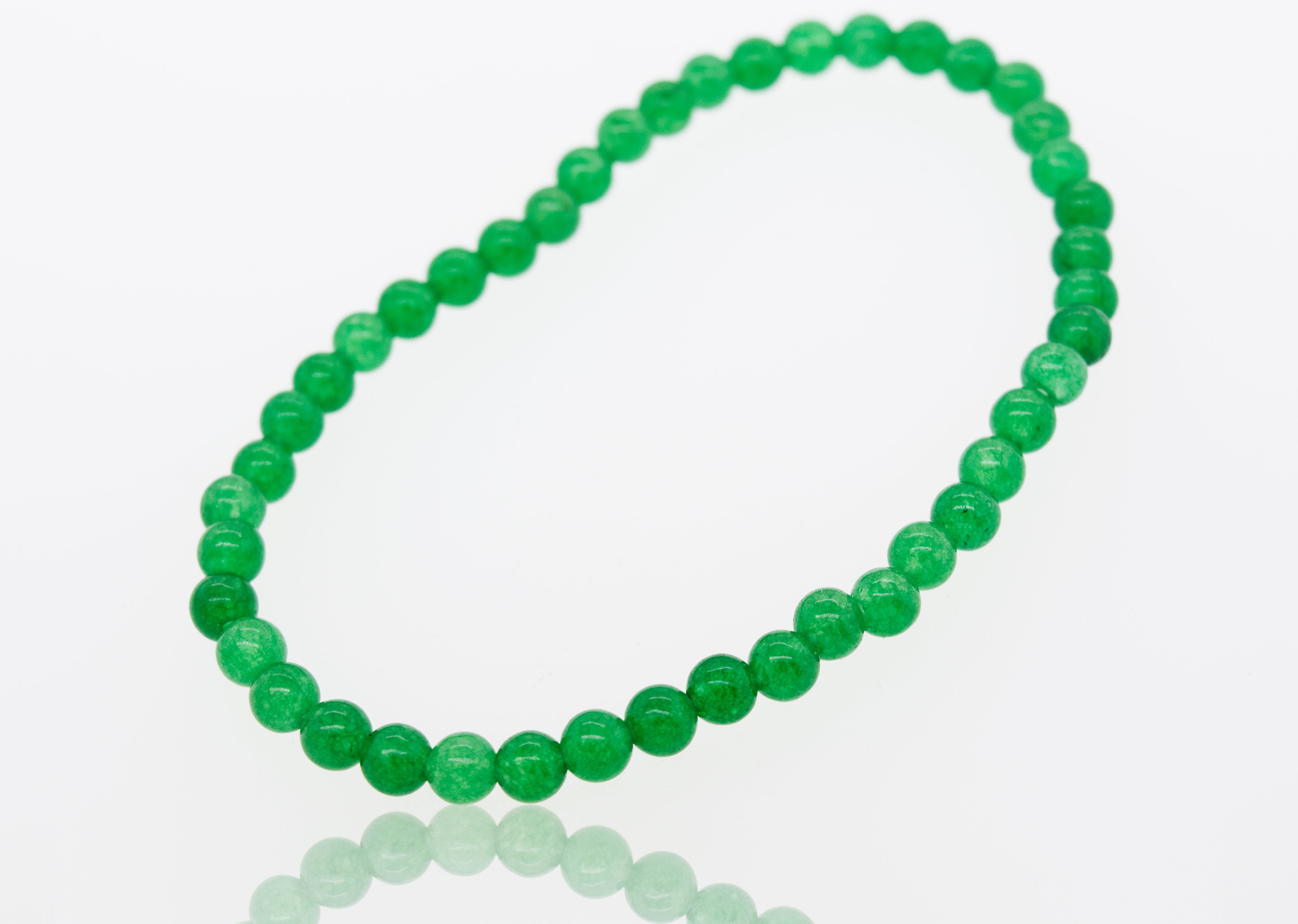 A Small Stone Beads Bracelet by Super Silver featuring six different gemstones, resting on a white surface.