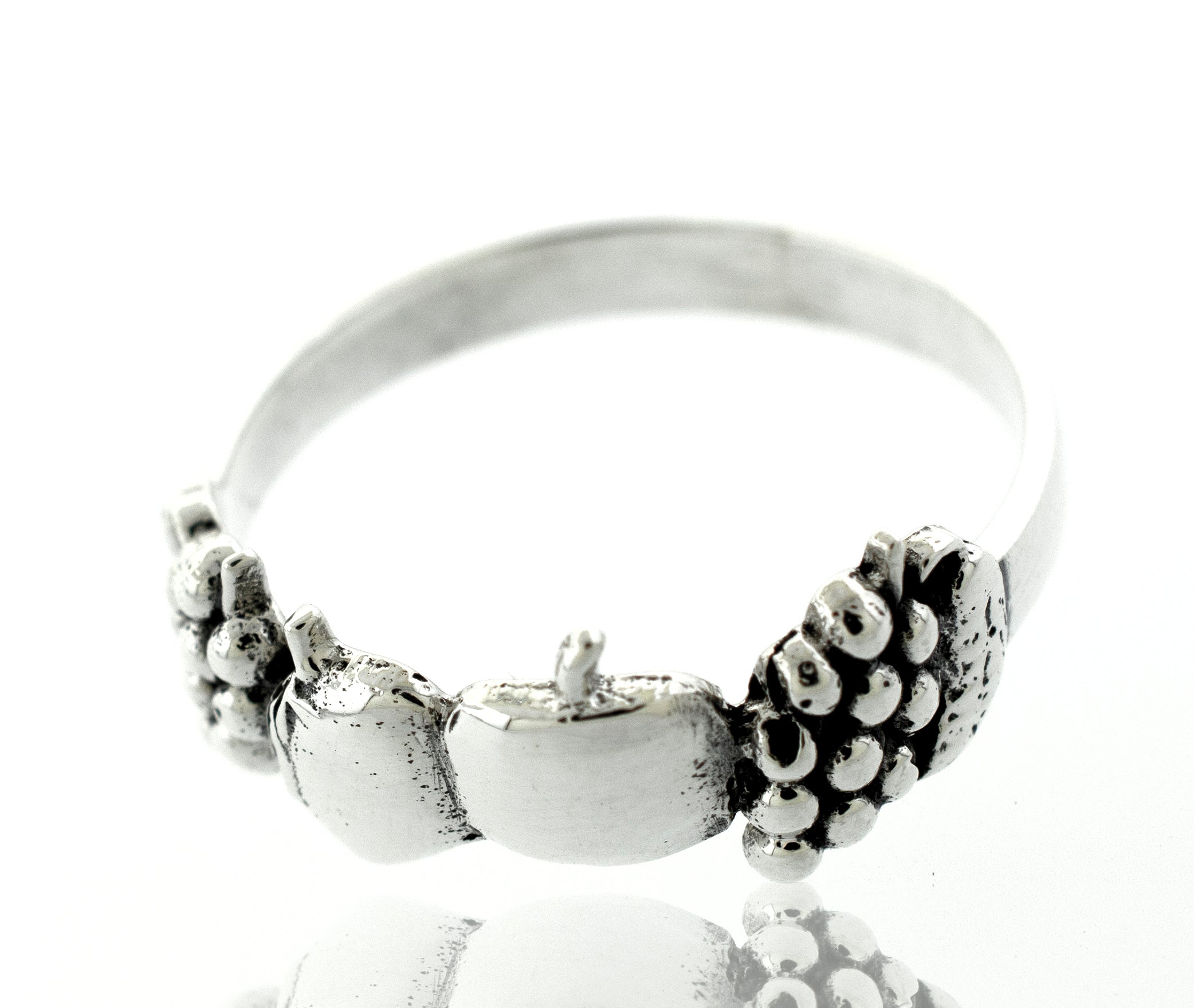 A minimalist Apples And Grapes Design Ring with a lotus flower on it.