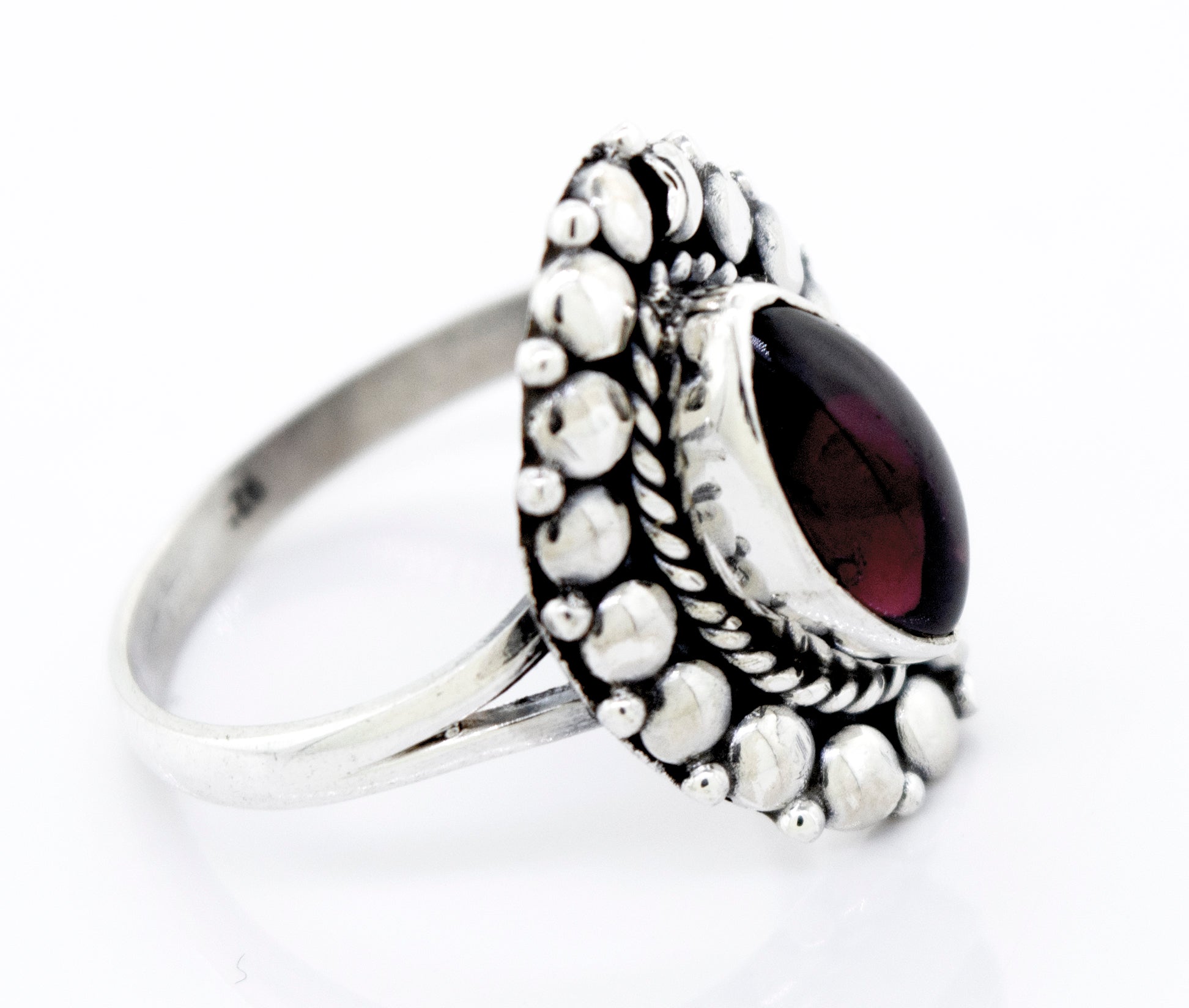 A Super Silver Marquise Shaped Vibrant Garnet Ring with a silver setting.