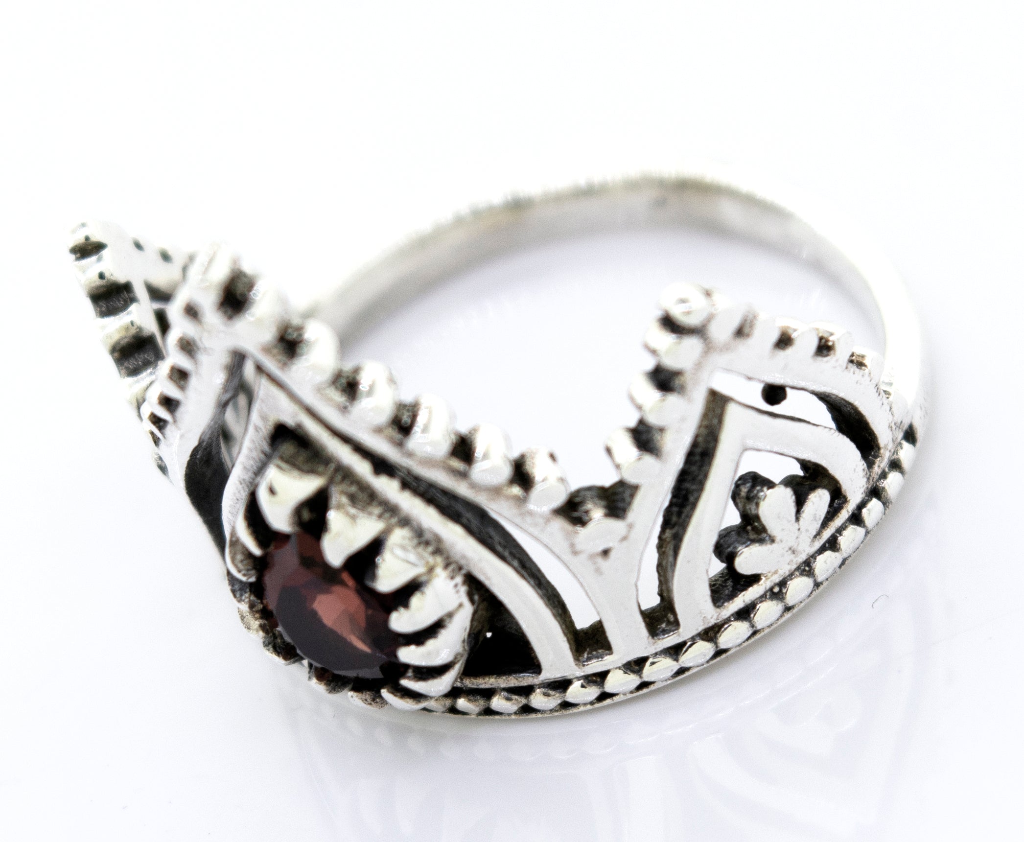 A Super Silver Silver Crown Ring With Teardrop Shape Garnet adorned with a captivating garnet stone.