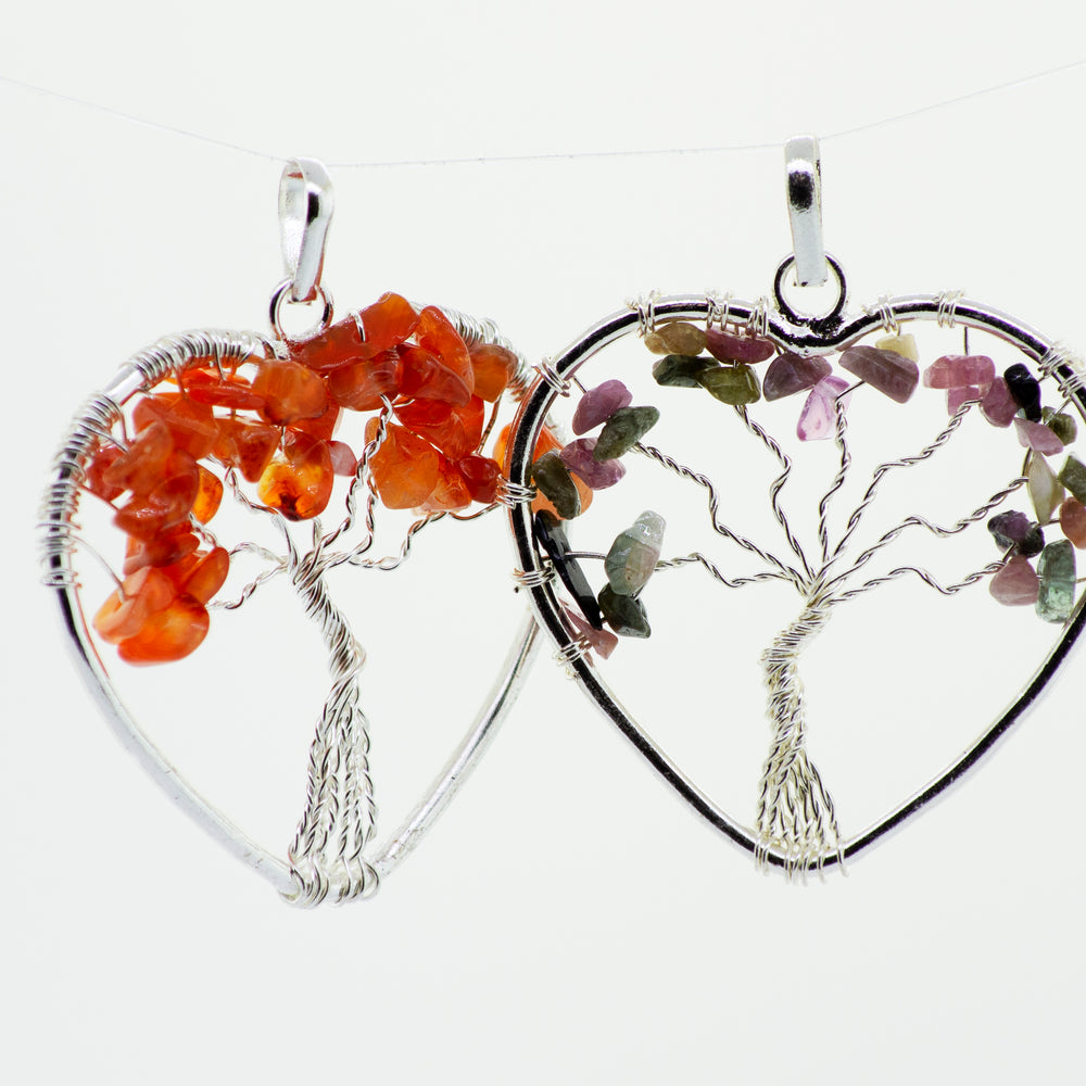 
                  
                    A Super Silver wire wrapped pendant featuring a Heart Shaped Tree of Life design, with two heart shapes on either side.
                  
                