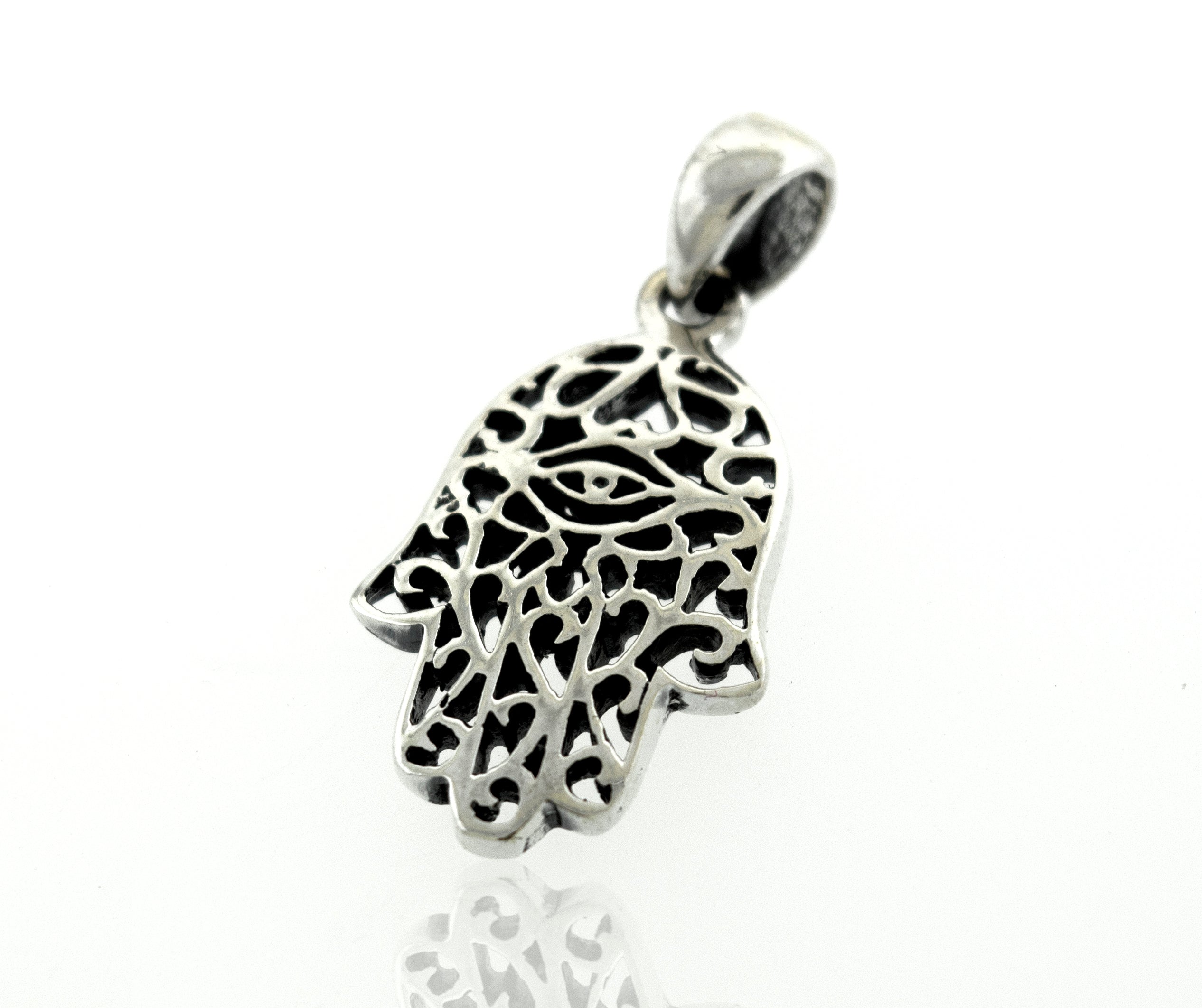 A Super Silver Hamsa Hand Pendant with a freestyle swirl design on a white surface.
