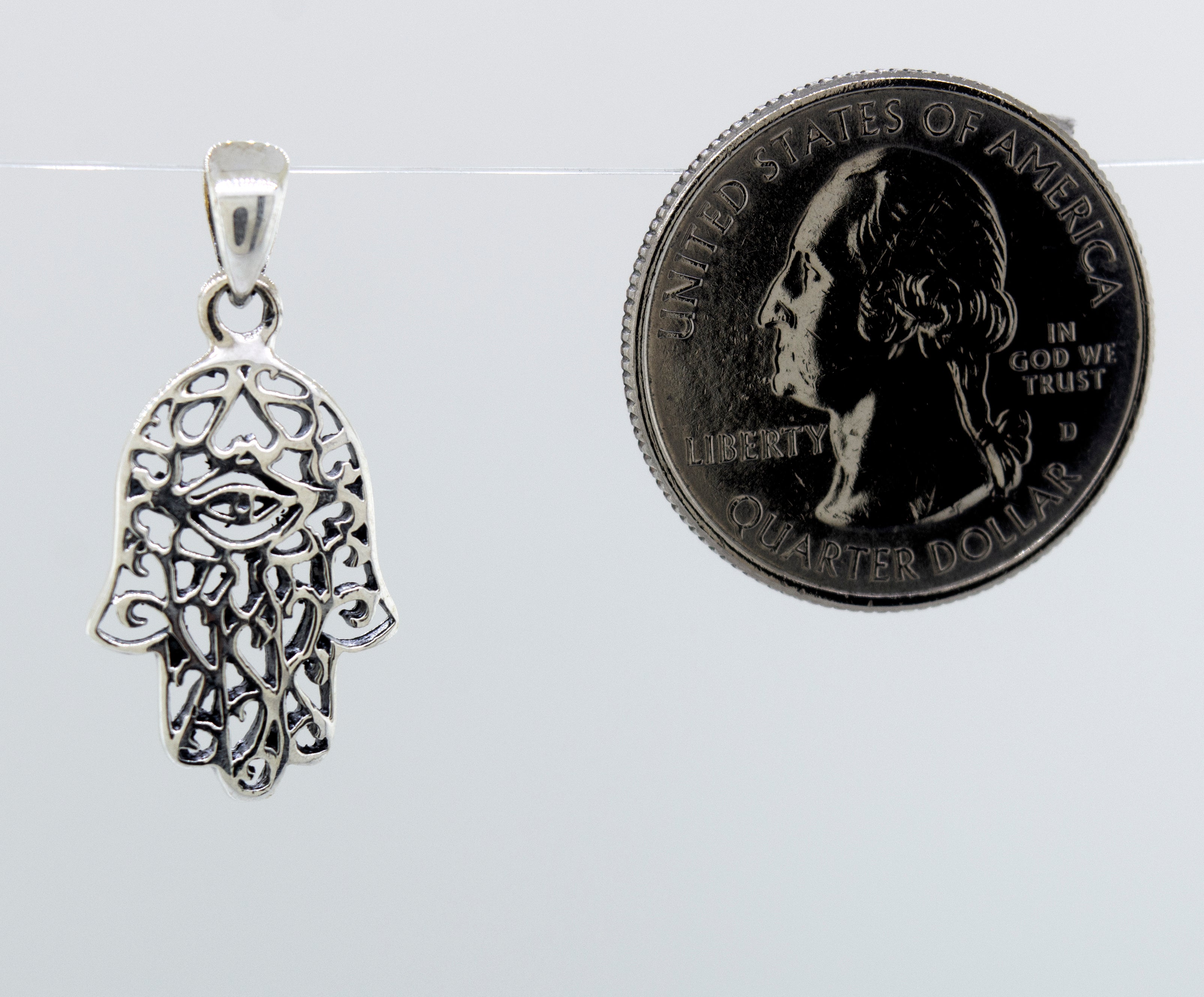A Super Silver Hamsa Hand Pendant with an evil eye and a freestyle swirl design.