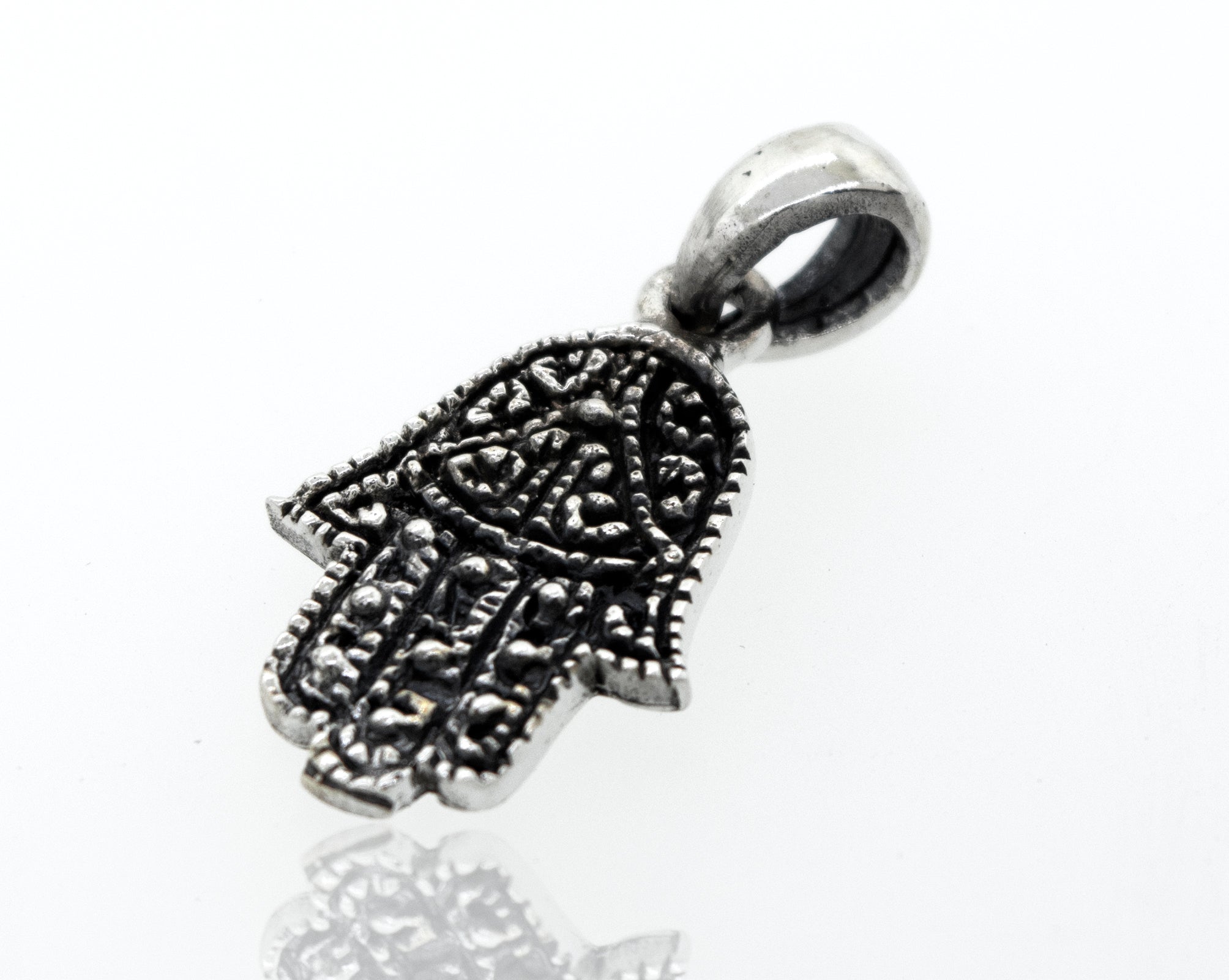 A small Super Silver Hamsa Hand Pendant on an oxidized background.