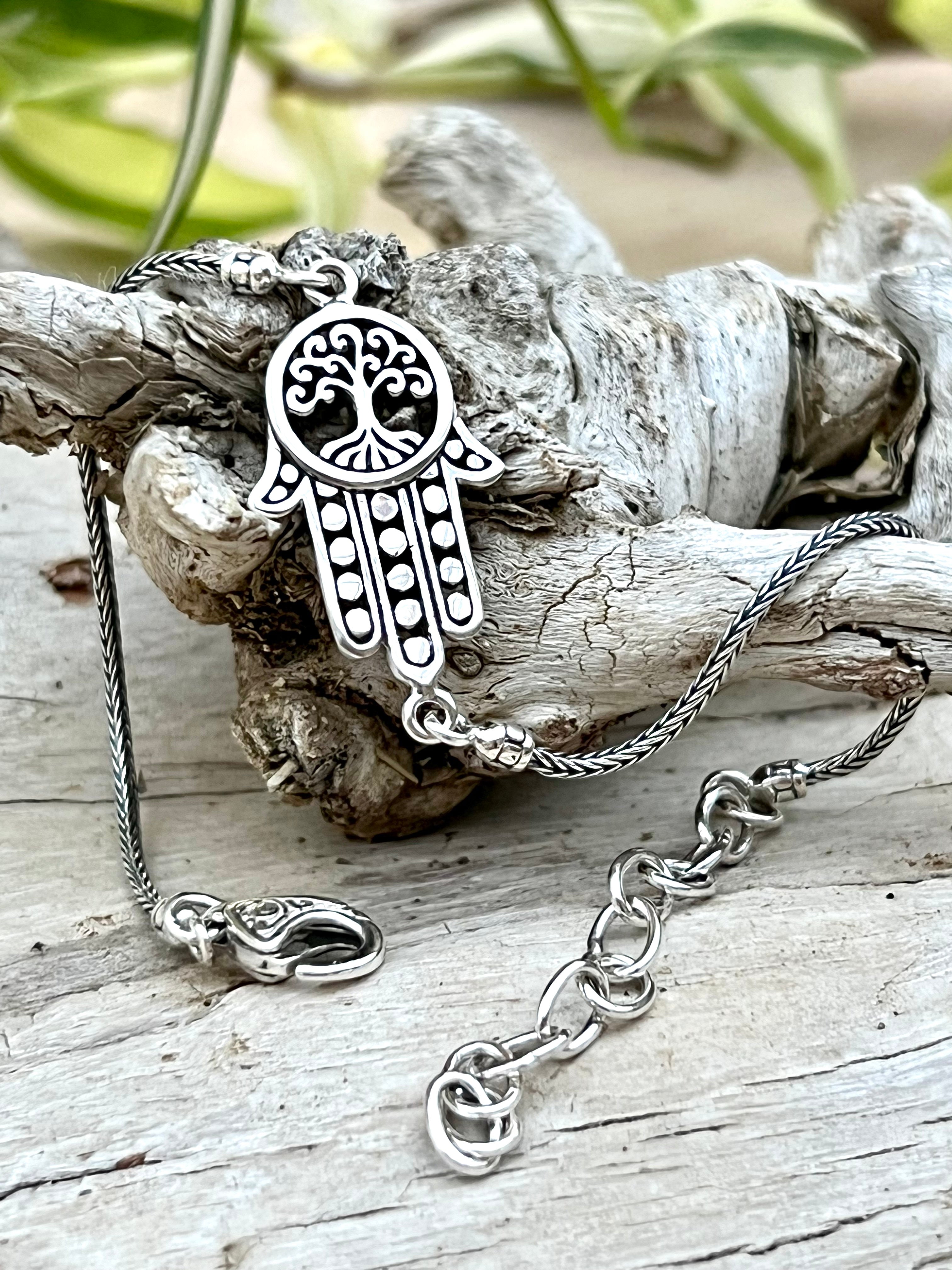 An elegant Hamsa with Tree of Life Bracelet by Super Silver, perfect for everyday wear, delicately crafted and displayed on a piece of wood from our Artisan Collections.
