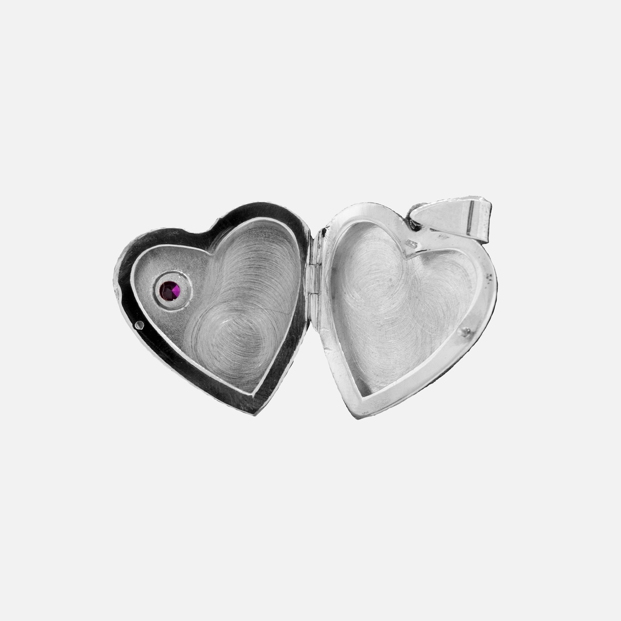 A Super Silver Heart Shaped Locket with Stone and lacy Etching with a romantic charm and an amethyst stone.