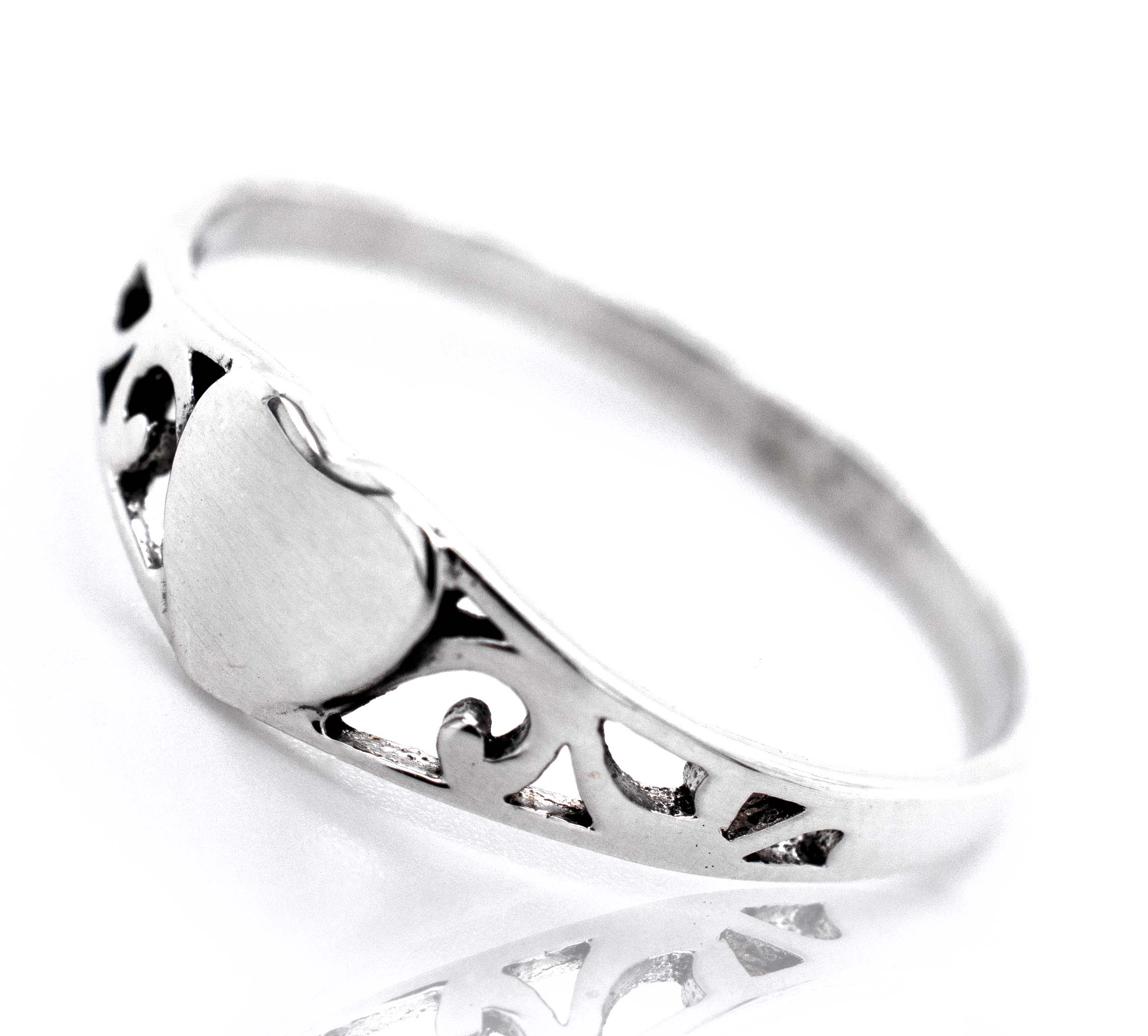 A minimalist sterling silver Heart Ring With Swirl Design.