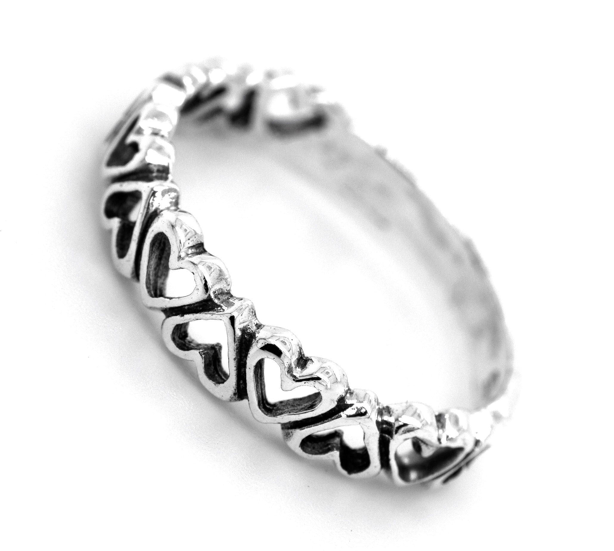 A Cut Out Alternating Heart Band adorned with miniature hearts, symbolizing love and ideal for engagement.
