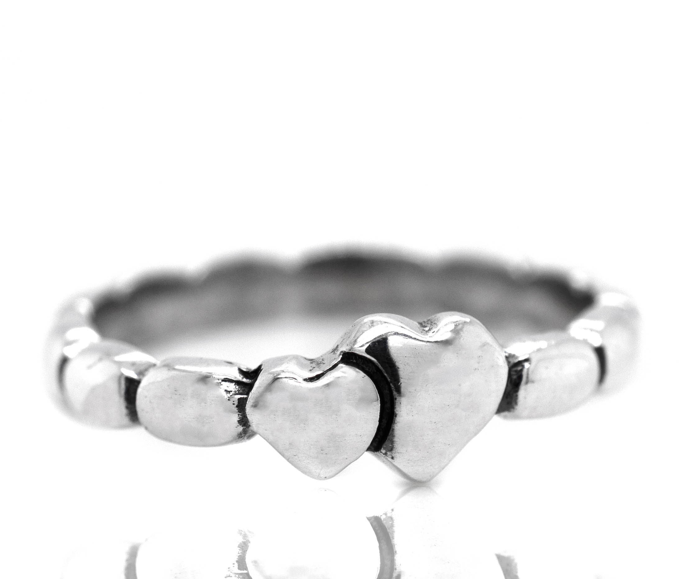 A minimalist silver Dainty Double Heart Band with two heart-shaped detailing, perfect for engagement or as a heartfelt gesture.