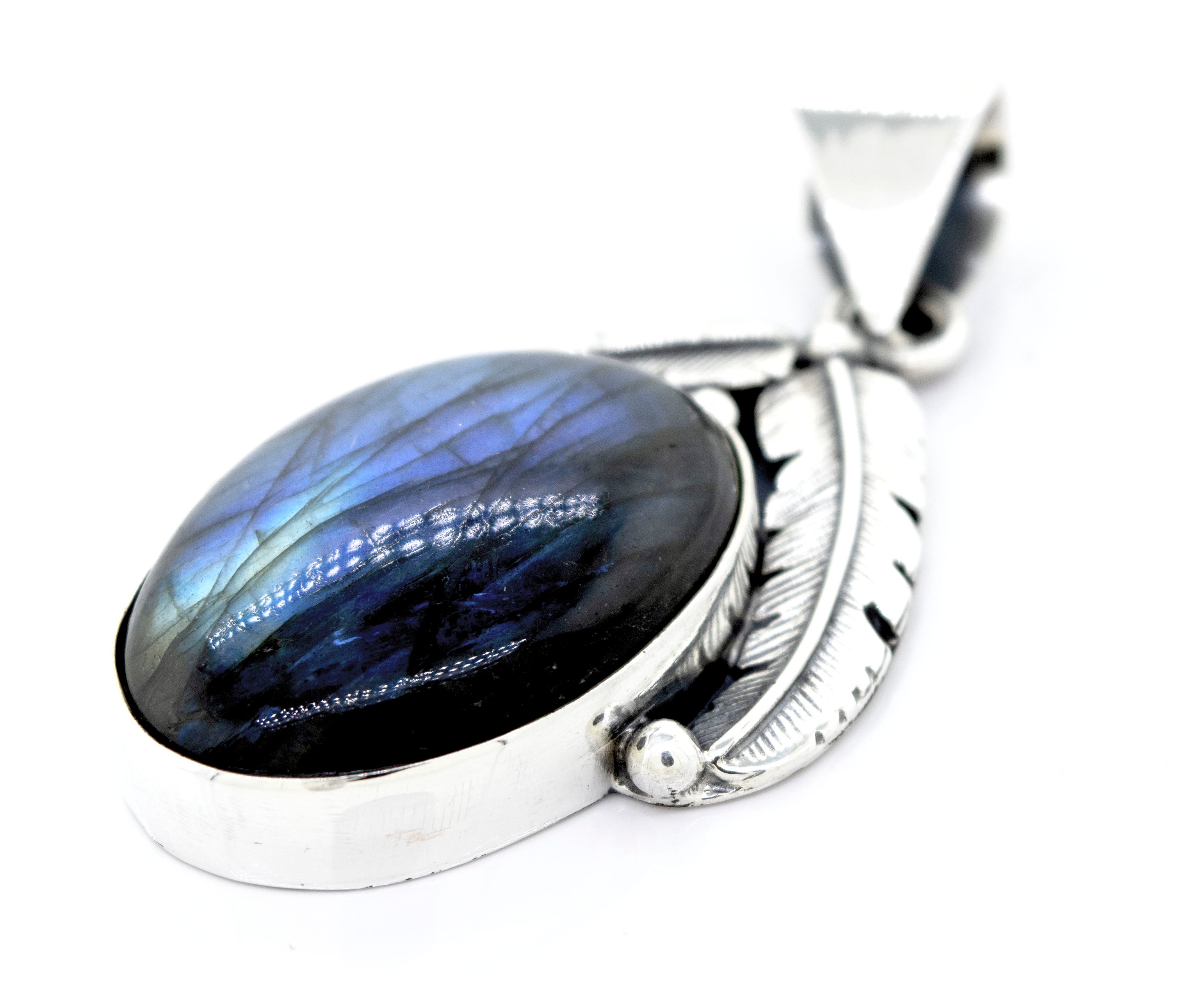 Beautiful Southwest Stone Pendant featuring an oval-shaped labradorite gemstone and an intricate feather design.