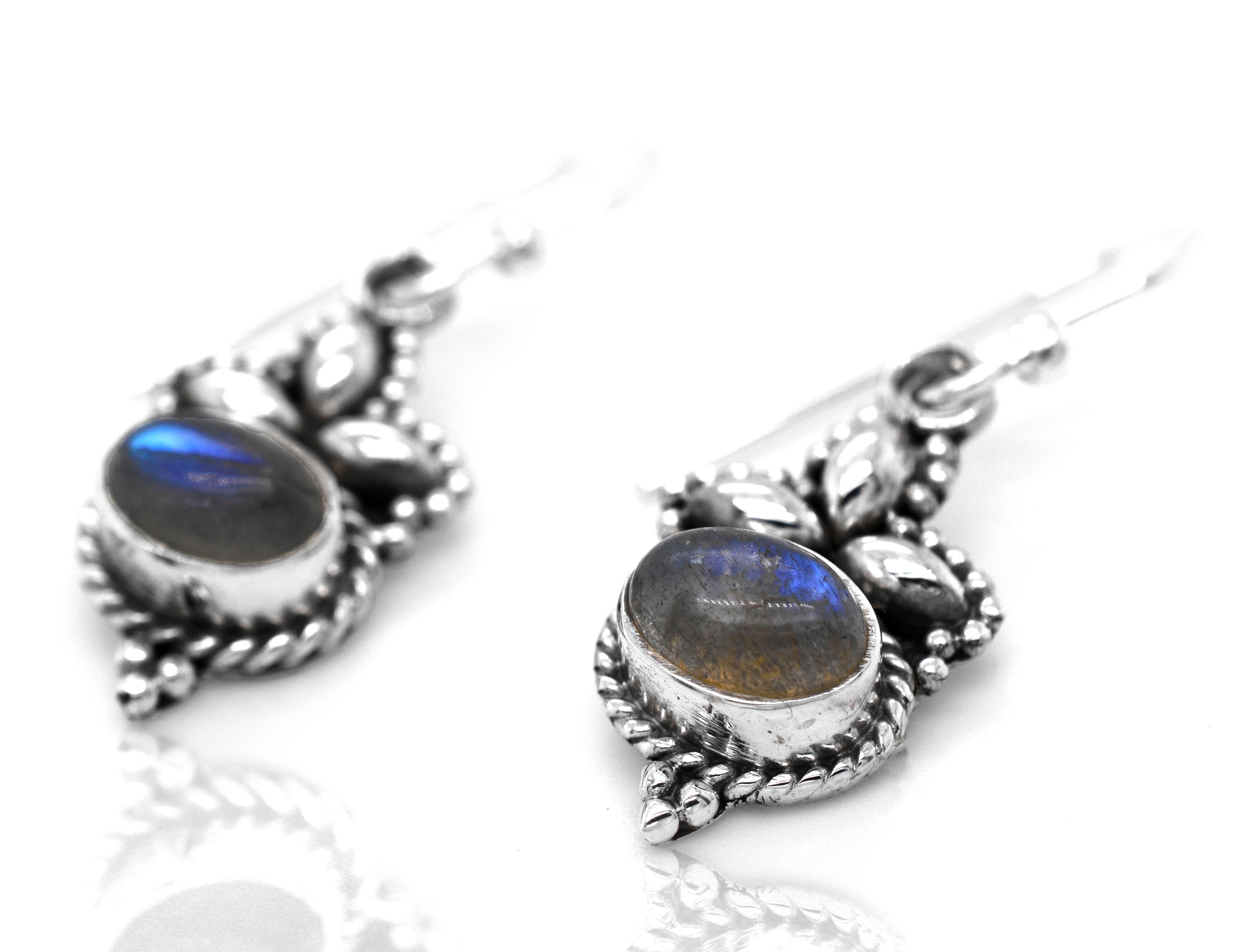 A pair of Super Silver's Captivating Petite Stone Earrings with labradorite stones - perfect for those who appreciate dainty jewelry and stunning gemstones.