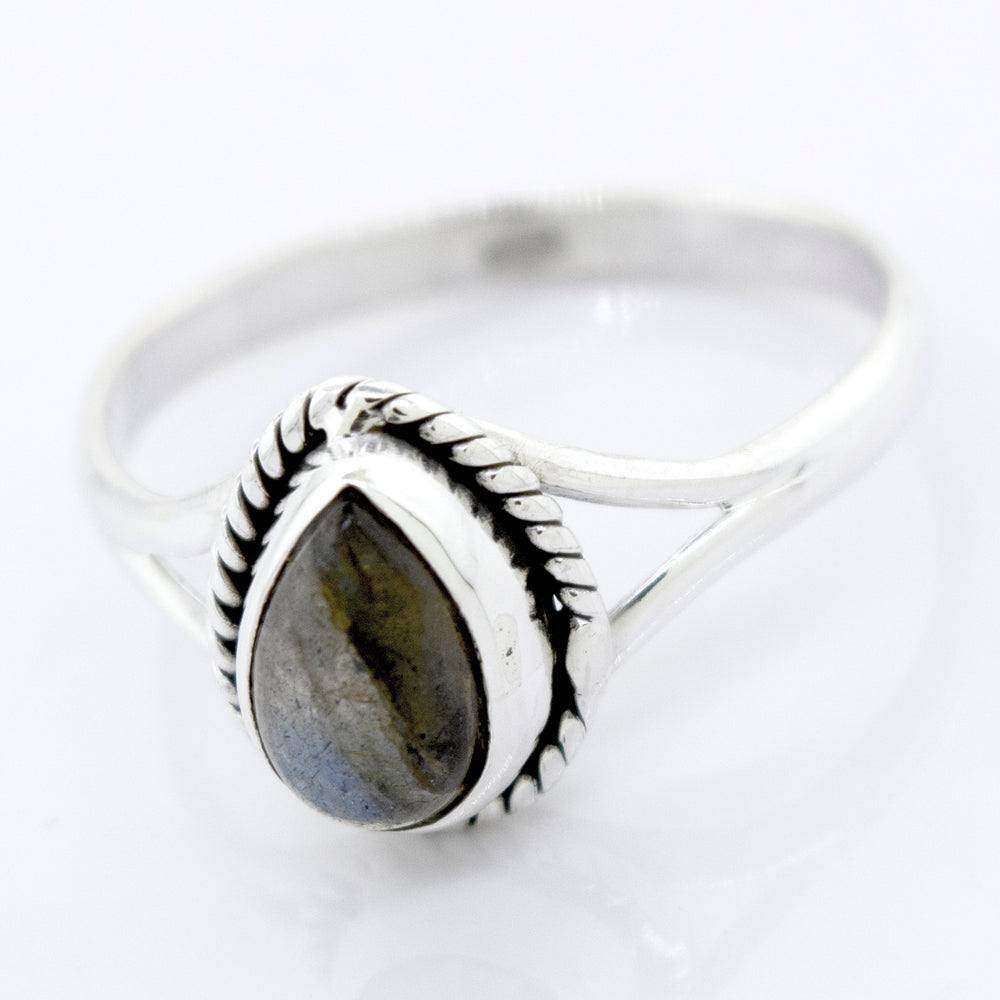 Vibrant Teardrop Shape Stone Ring with a pear-shaped, bezel-set gray stone on a white background.