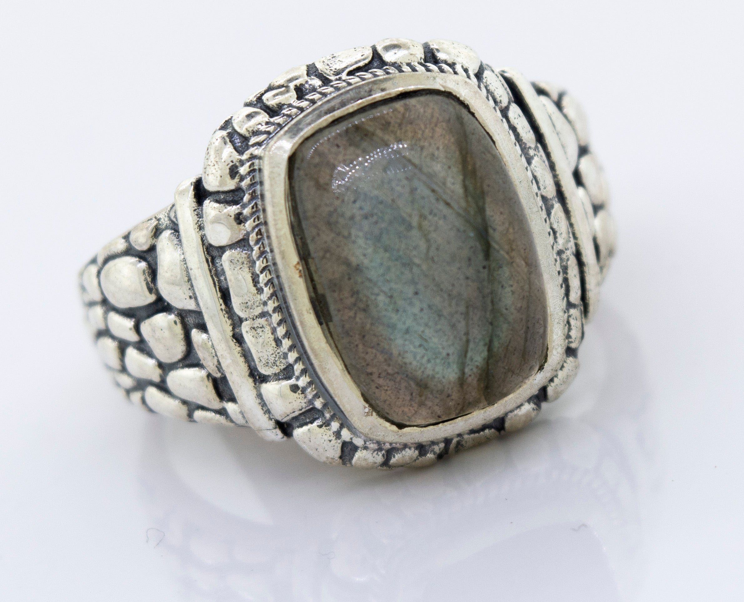 A minimalist silver Labradorite Signet Ring With Dragon Scale Pattern.