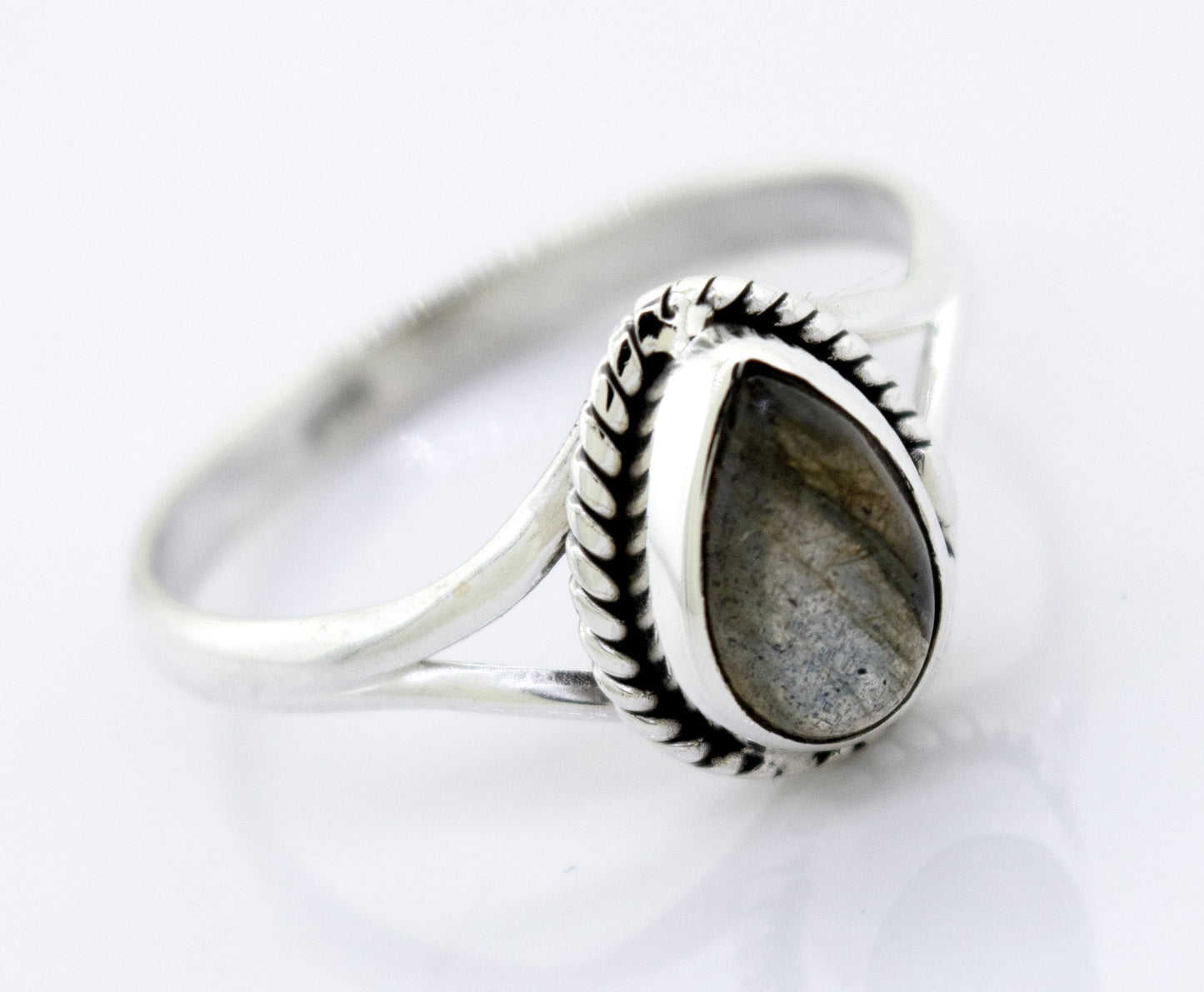 Vibrant teardrop shape stone ring with an oval gray gemstone set in a detailed band, displayed against a white background.